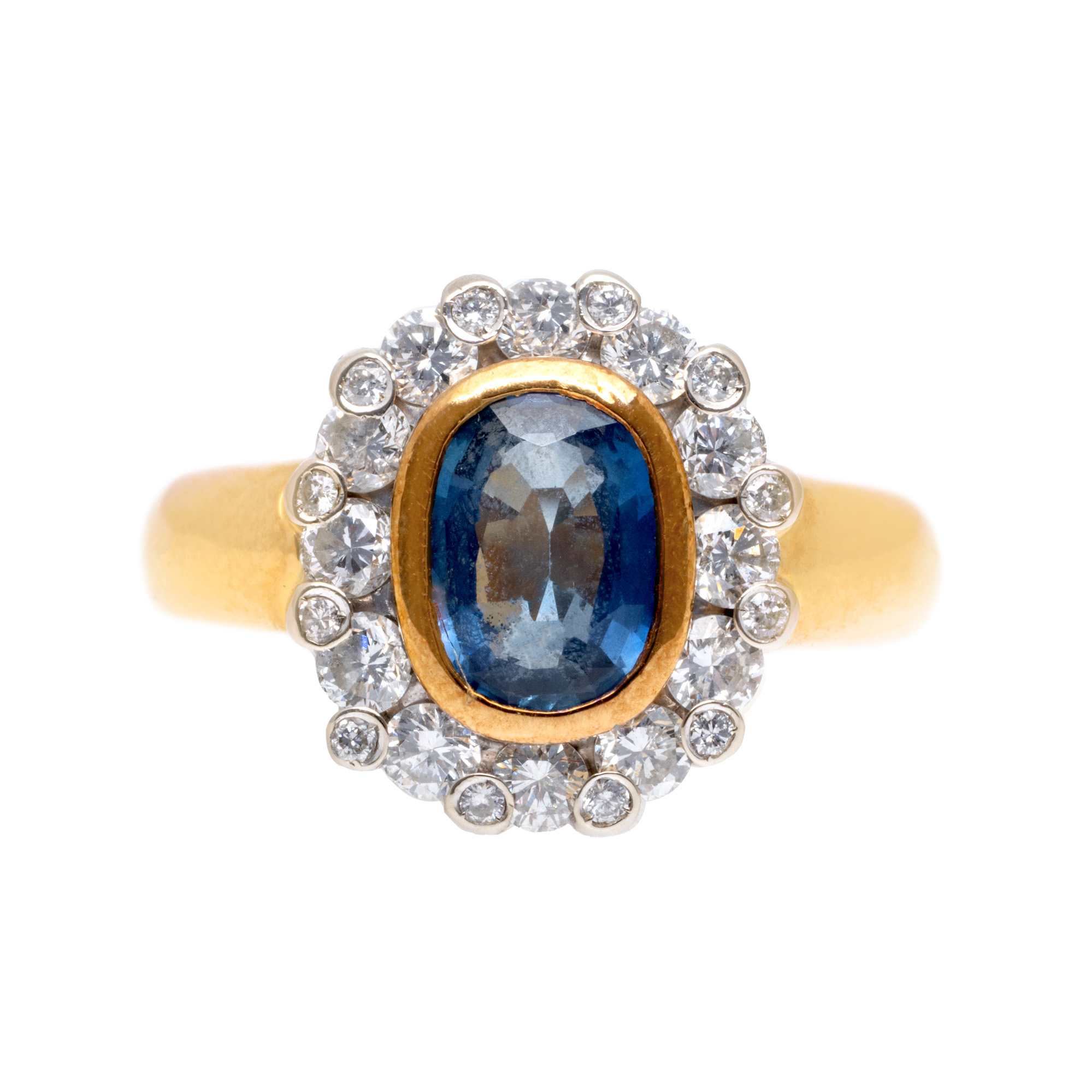 Two-tone gold ring, adorned with a central sapphire surrounded by diamonds
