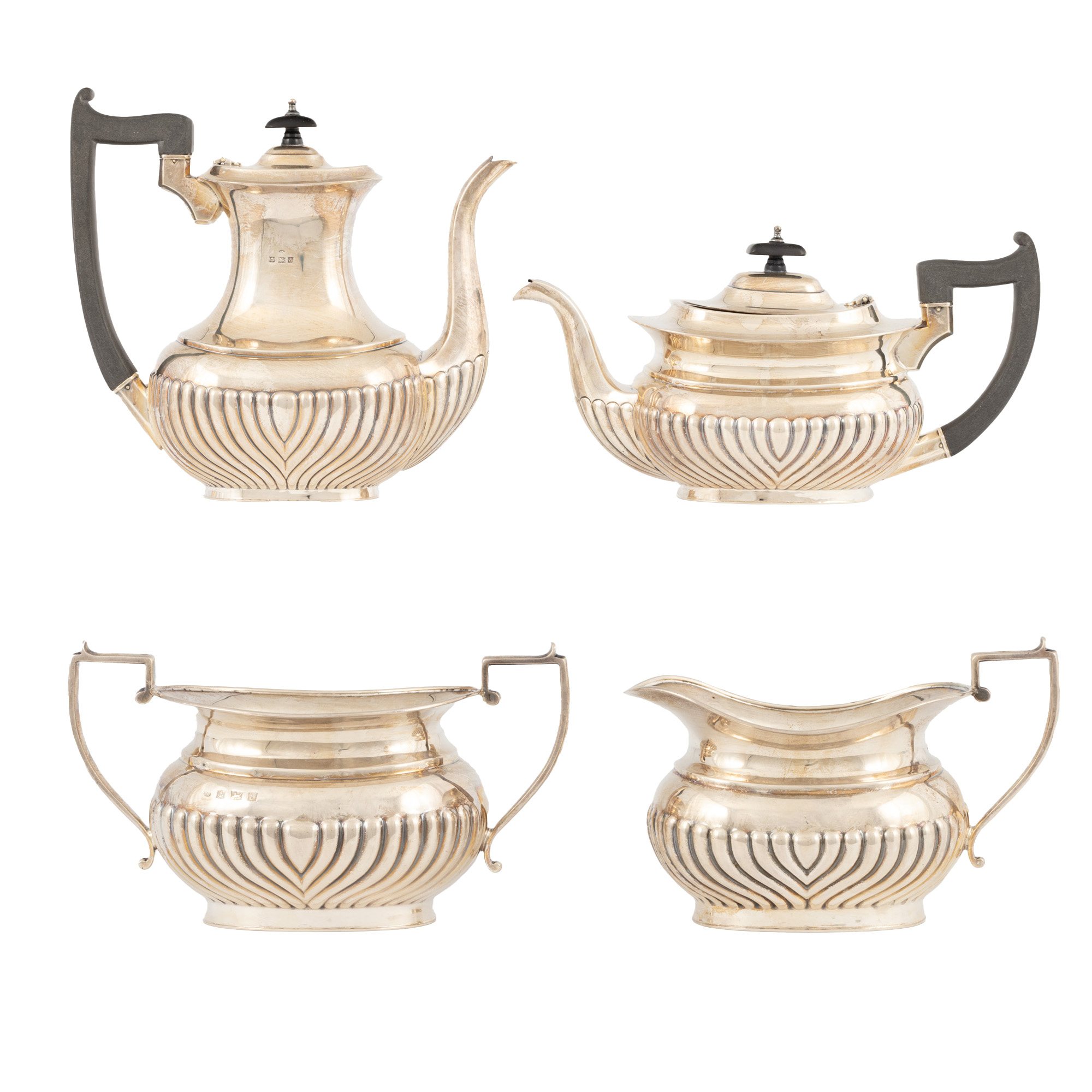 Silver tea and coffee service, consisting of teapot, coffee pot, sugar bowl, and creamer.