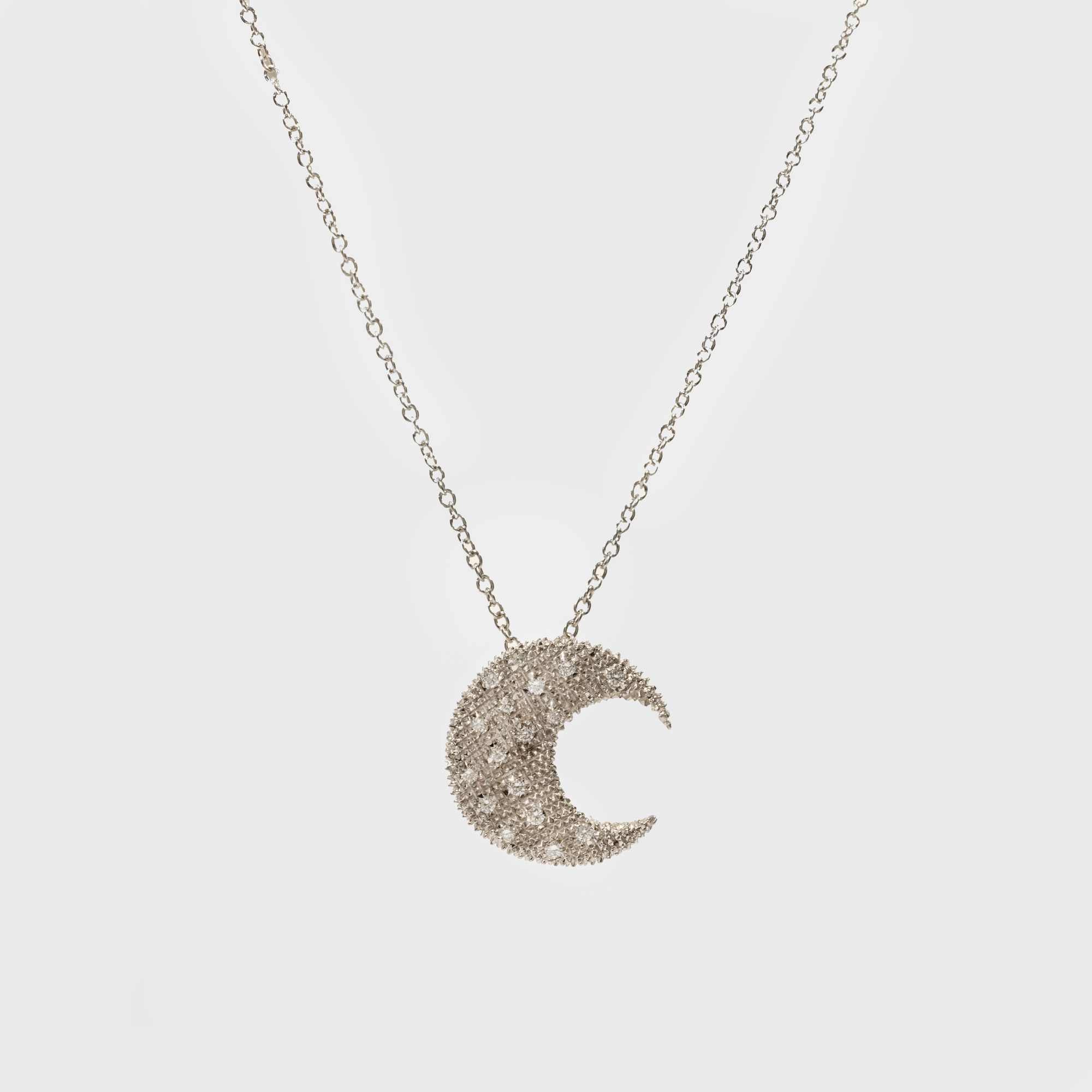 White gold chain with moon-shaped pendant, decorated with diamonds