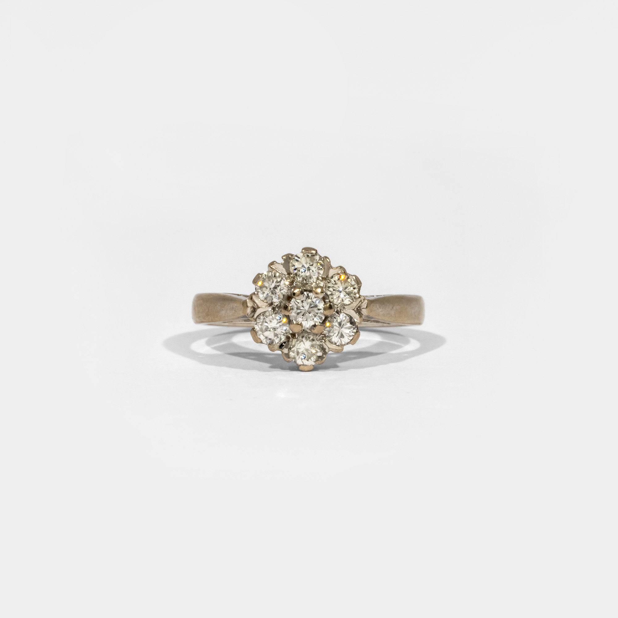White gold ring in the shape of a flower, decorated with diamonds