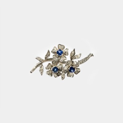 White gold brooch, decorated with sapphires and diamonds, in the form of a blooming branch