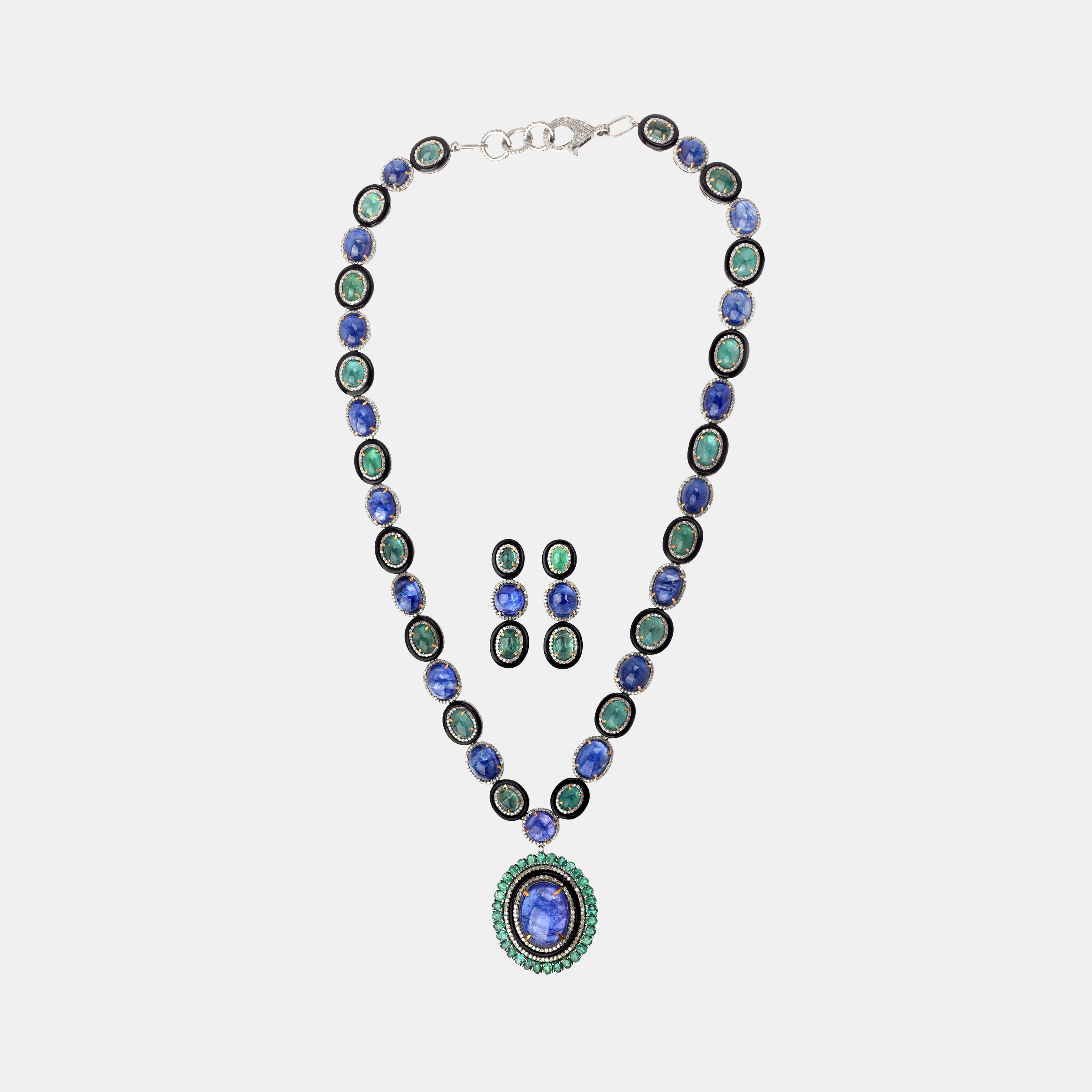 Silver set, consisting of necklace and pair of earrings, decorated with sapphires, tanzanites, emeralds, diamonds, and onyx