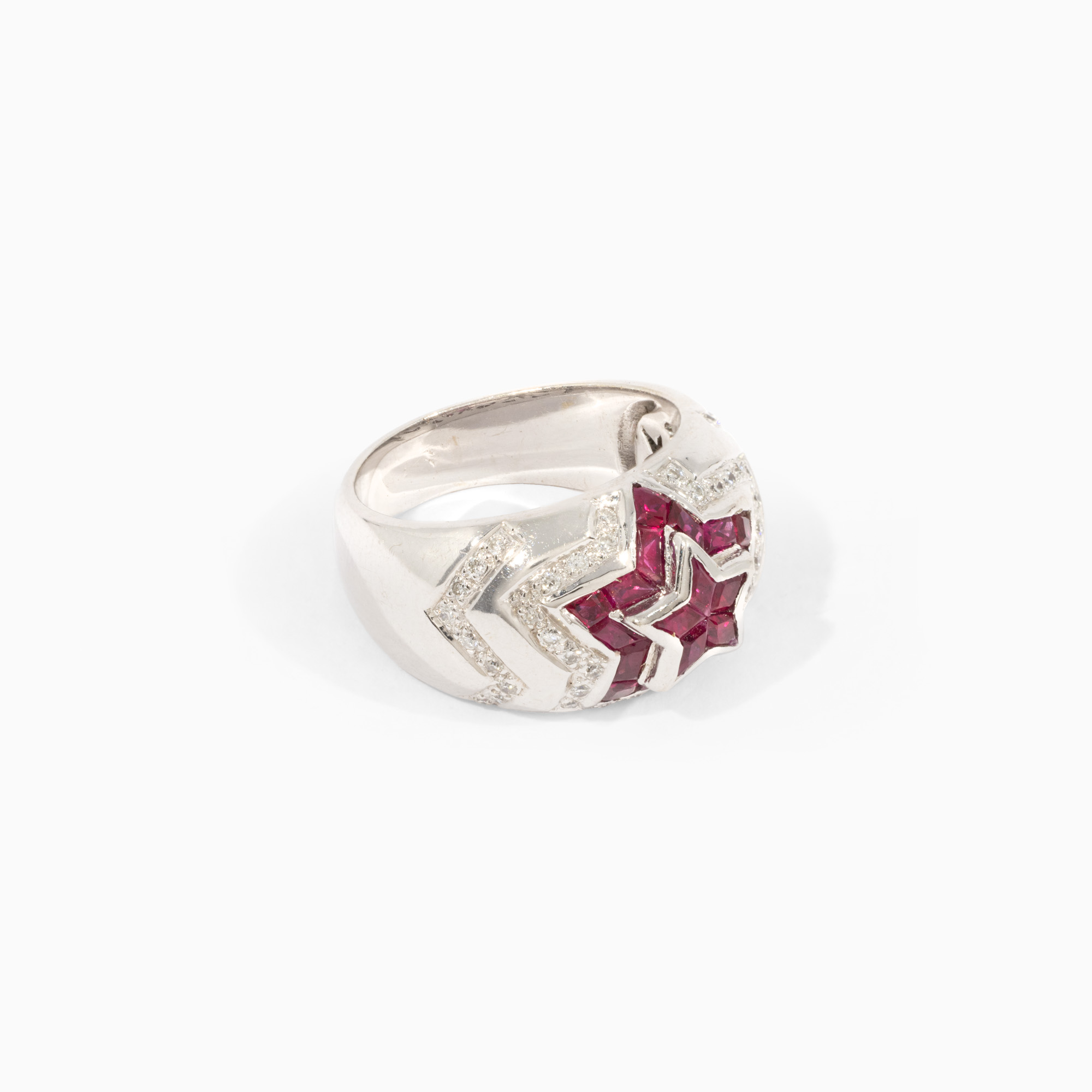 White gold ring in the shape of a star, decorated with rubies and diamonds