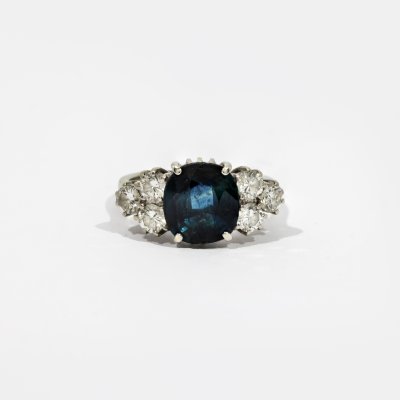 White gold ring adorned with a sapphire and diamonds