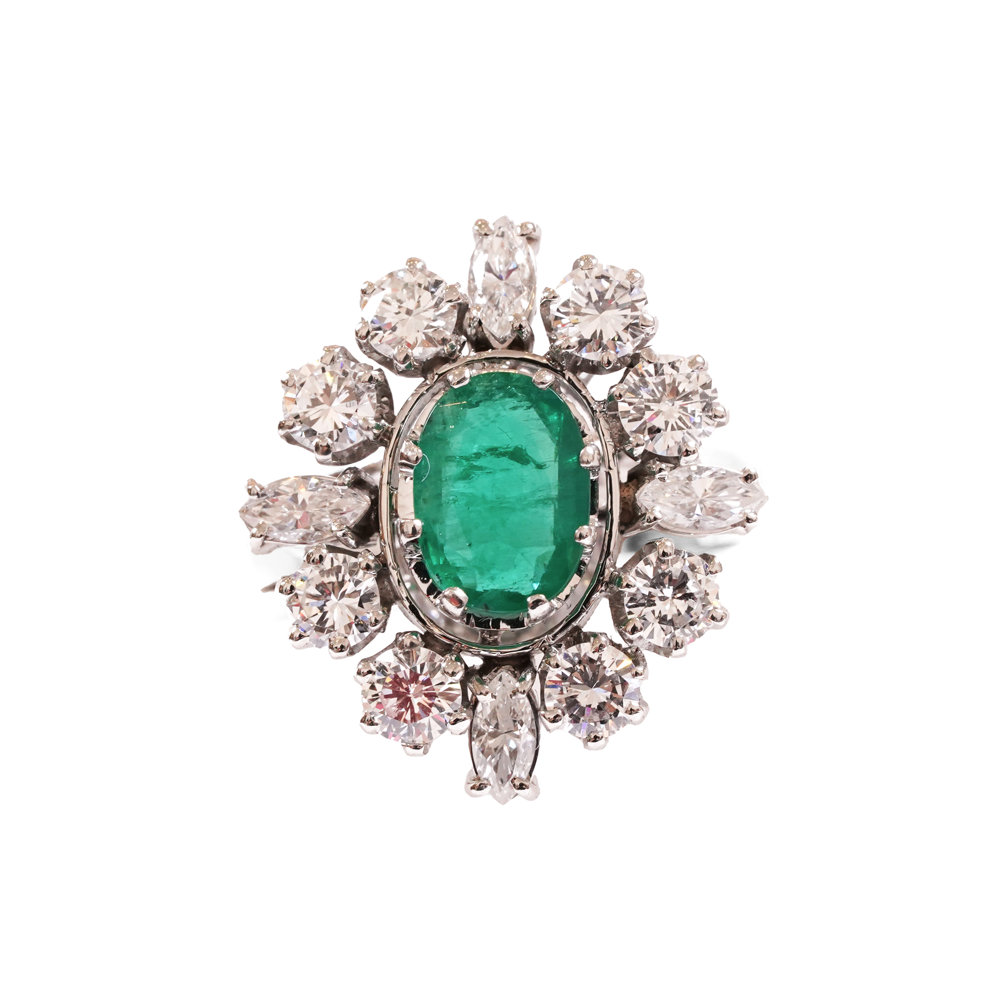 Platinum ring set with an emerald and diamonds