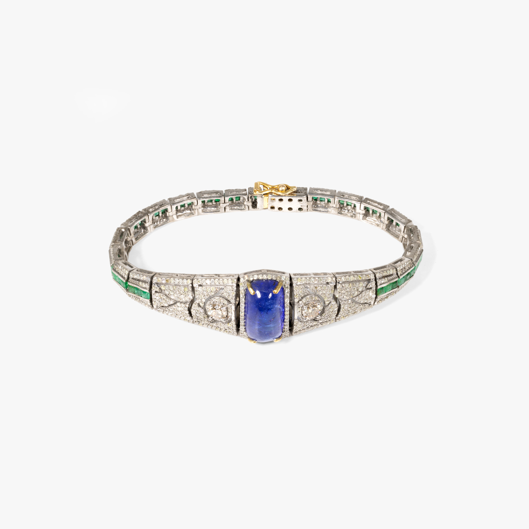 Gold and silver bracelet adorned with tanzanite, diamonds and emeralds