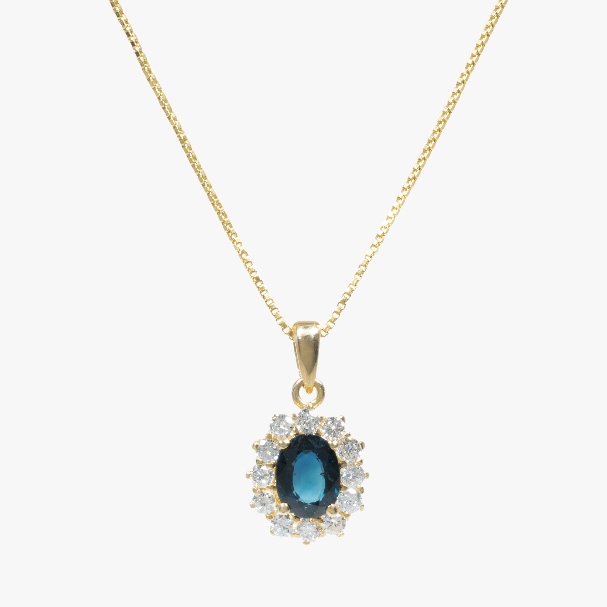 Gold chain with sapphire pendant, decorated with diamond entourage