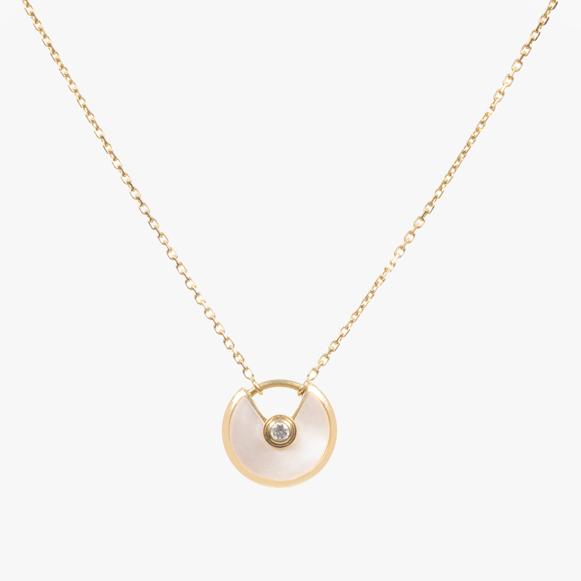 "Amulet" - Cartier pendant necklace in gold, decorated with diamond and mother of pearl, accompanied by the original box