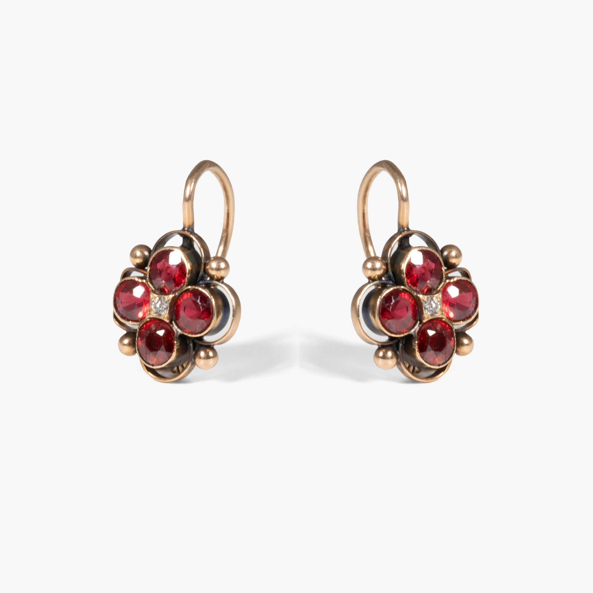 Pair of red gold earrings, decorated with rubies and diamonds, circa 1925