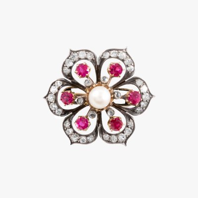 Edwardian style brooch, made of two-tone gold and silver, in the shape of a flower, decorated with rubies, pearl and diamonds
