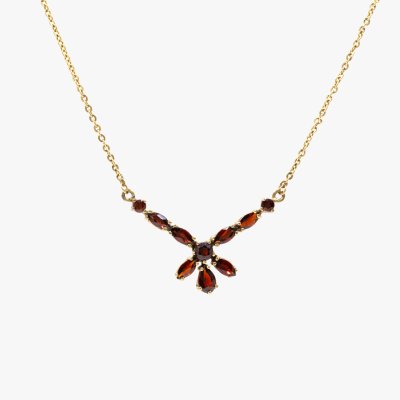 Delicate gold necklace, decorated with garnets