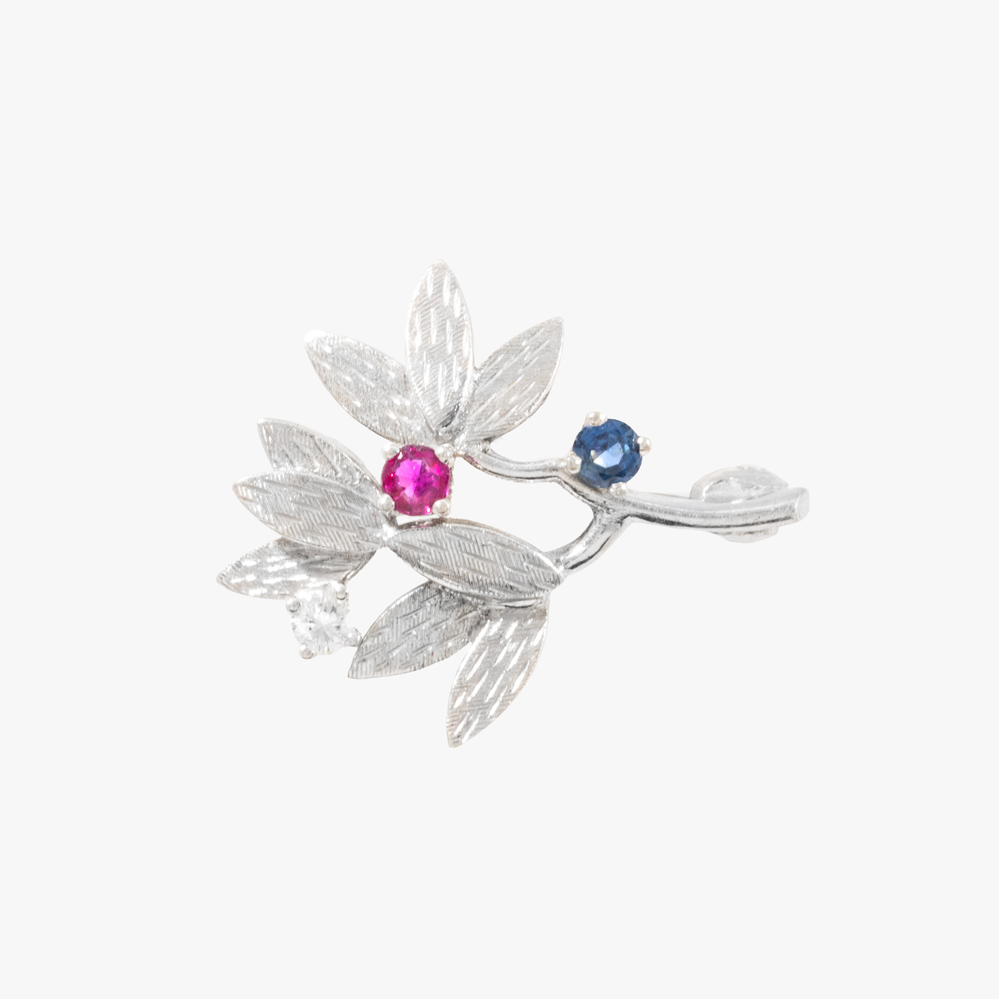 White gold brooch decorated with diamond, sapphire and ruby
