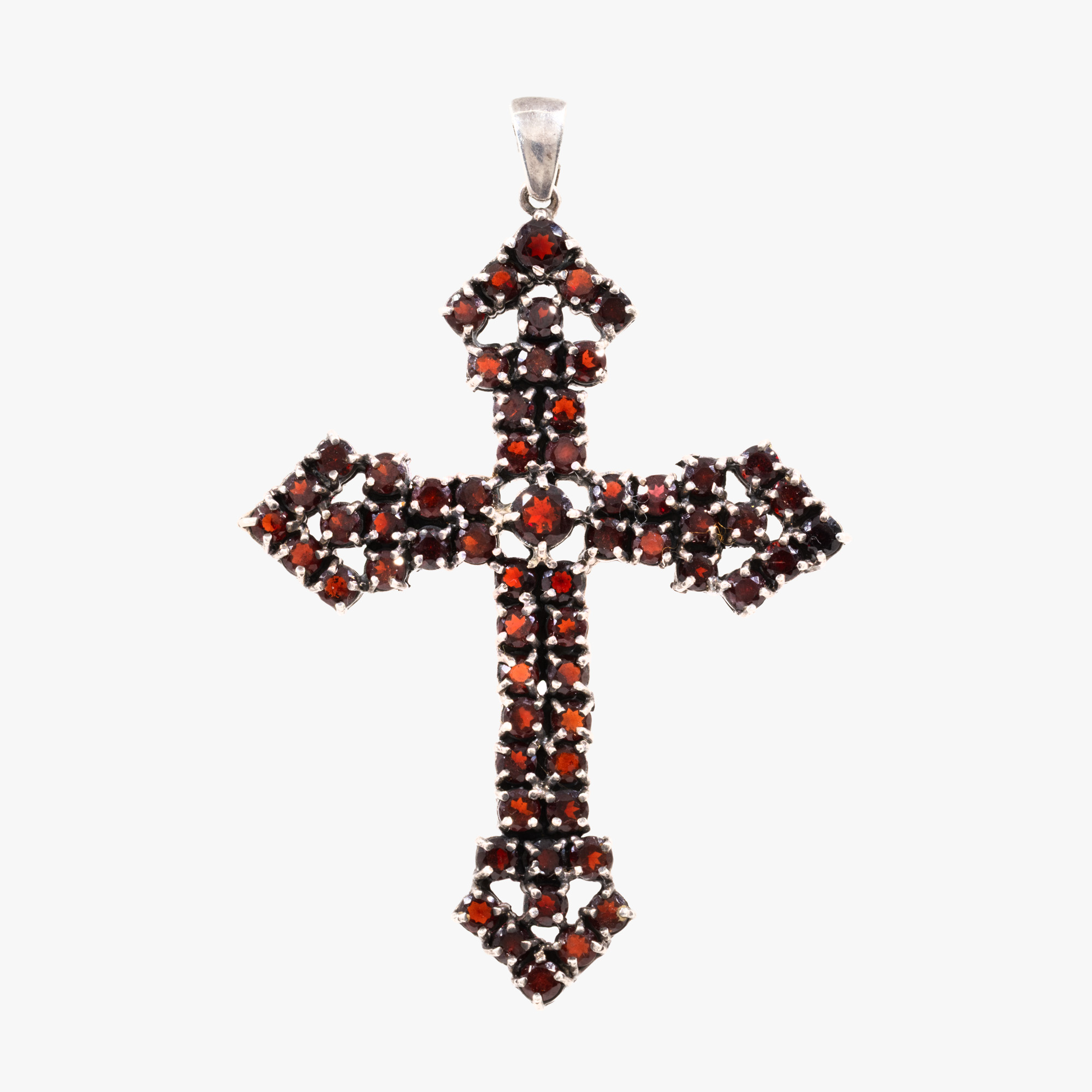 Silver pendant, in the shape of a cross, paved with garnets