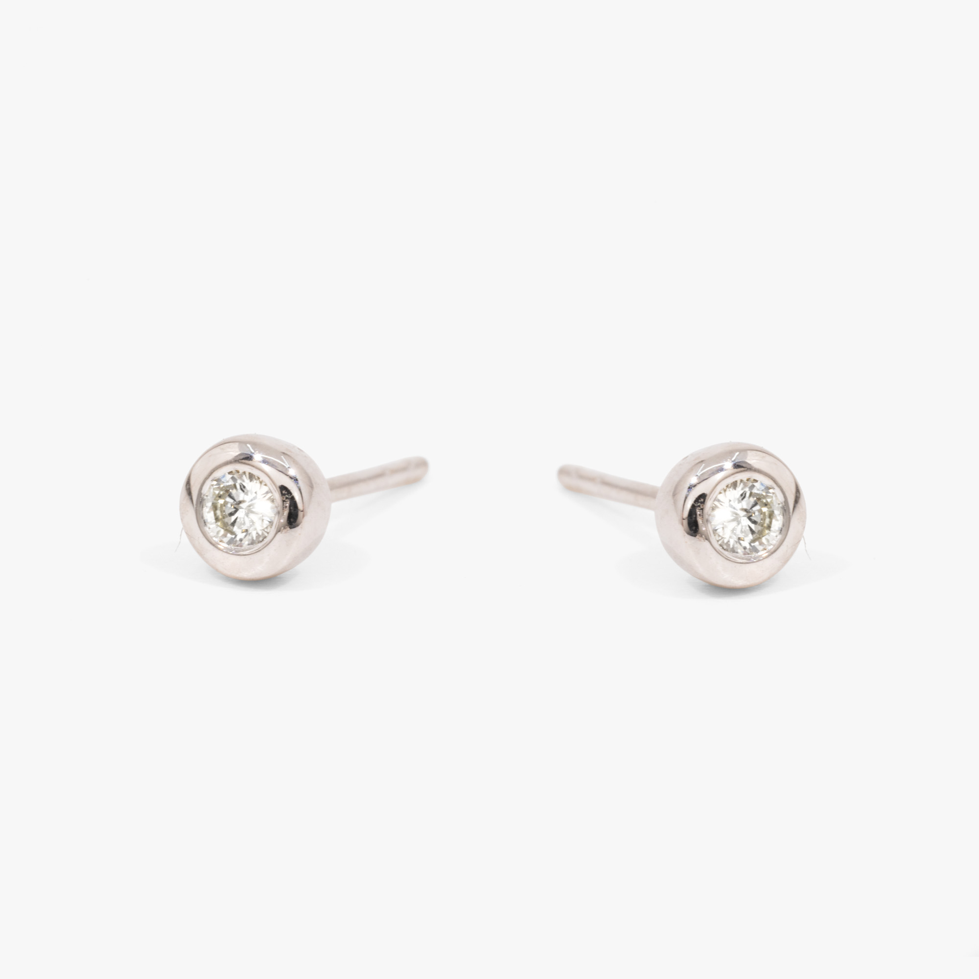 Pair of white gold earrings, decorated with two inset diamonds