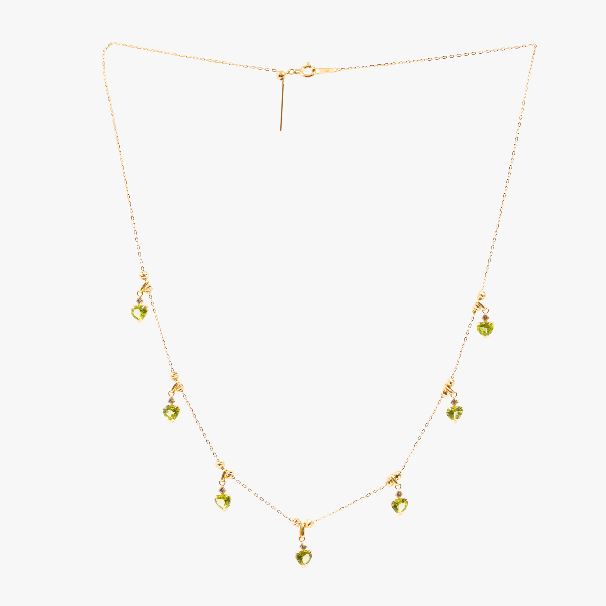 Gold necklace, decorated with heart-shaped pendants, with peridots and diamonds, accompanied by an additional gemological certificate
