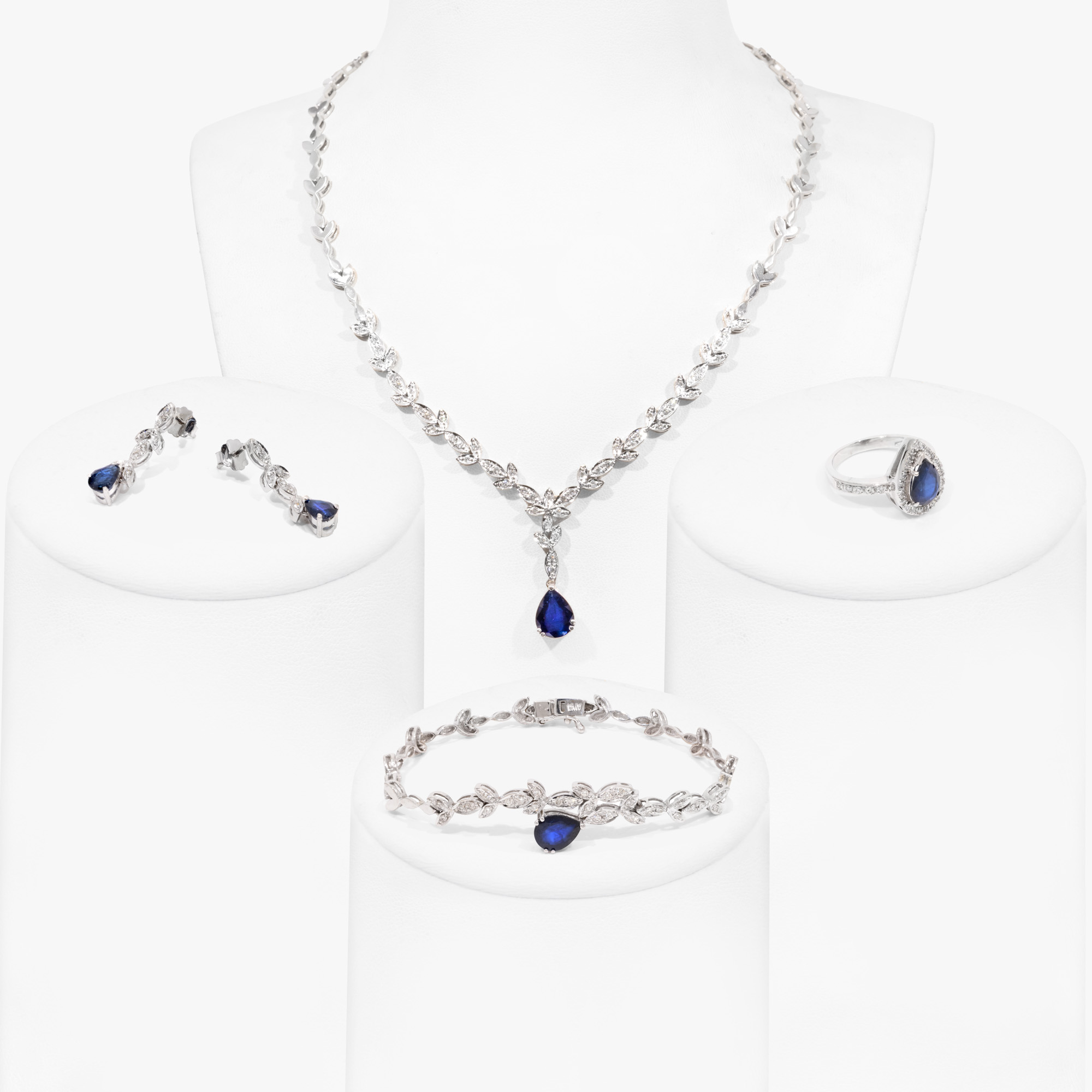White gold set, consisting of necklace, bracelet, earrings and ring, decorated with sapphires and diamonds