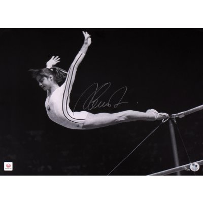 Photograph featuring Nadia Comăneci, during her parallel bars routine at the Montreal 1976 Olympic Games, with the athlete's holographic signature, framed