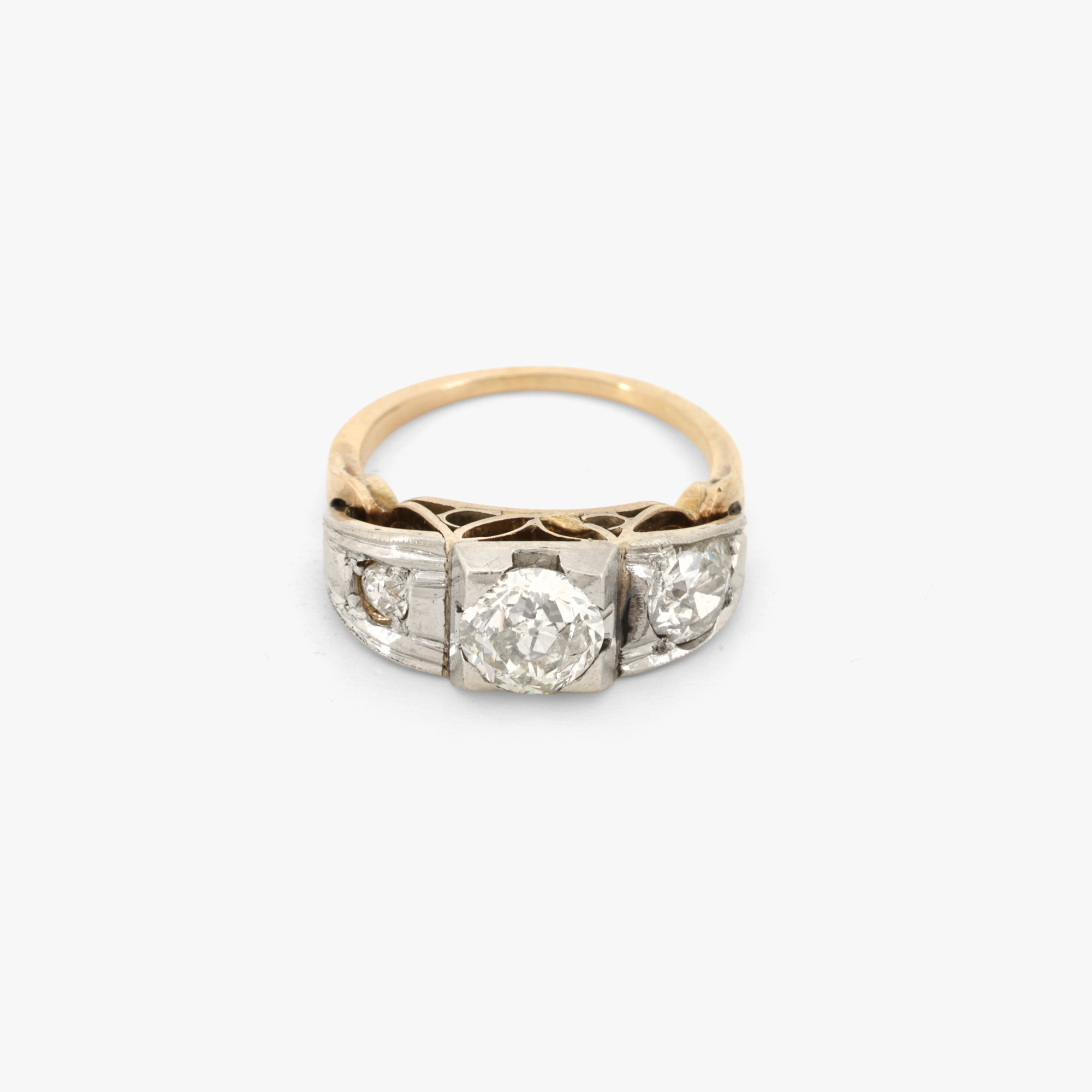 Gold and platinum ring, decorated with a triad of diamonds, circa 1920.