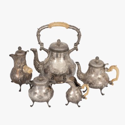 Neo-Rococo silver service, consisting of a water container, coffee pot, teapot, milk jug and sugar bowl, decorated with ivory, signed George Fouquet-Lapar, circa 1930, originating from the collection of General Mihai Caraman