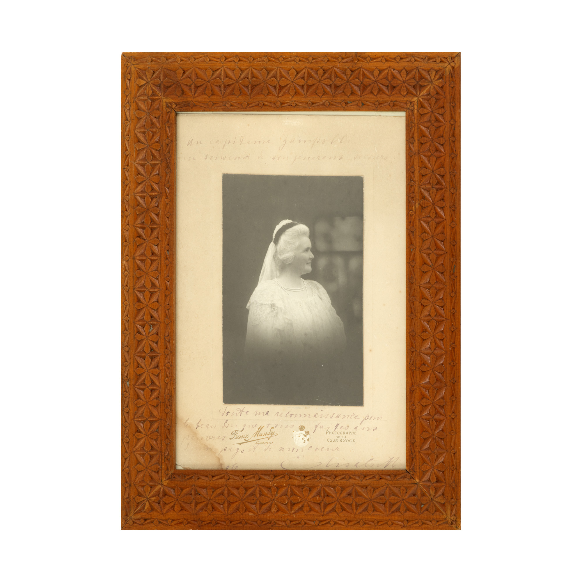Photograph depicting Queen Elisabeta, Franz Mandy photographic studio, Bucharest, 1906, with an extensive holographic dedication and the Queen's signature, in a hand-carved neo-Romanian frame