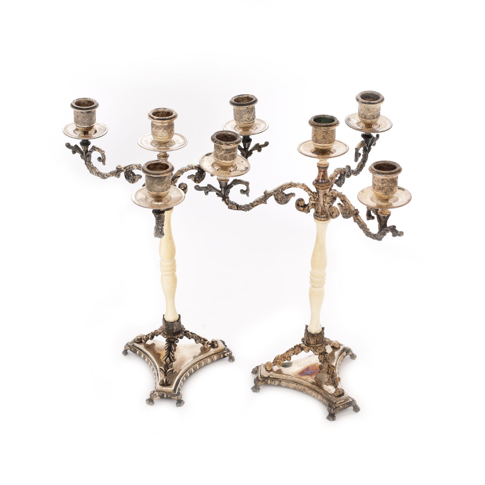 Pair of silver candlesticks on ivory feet