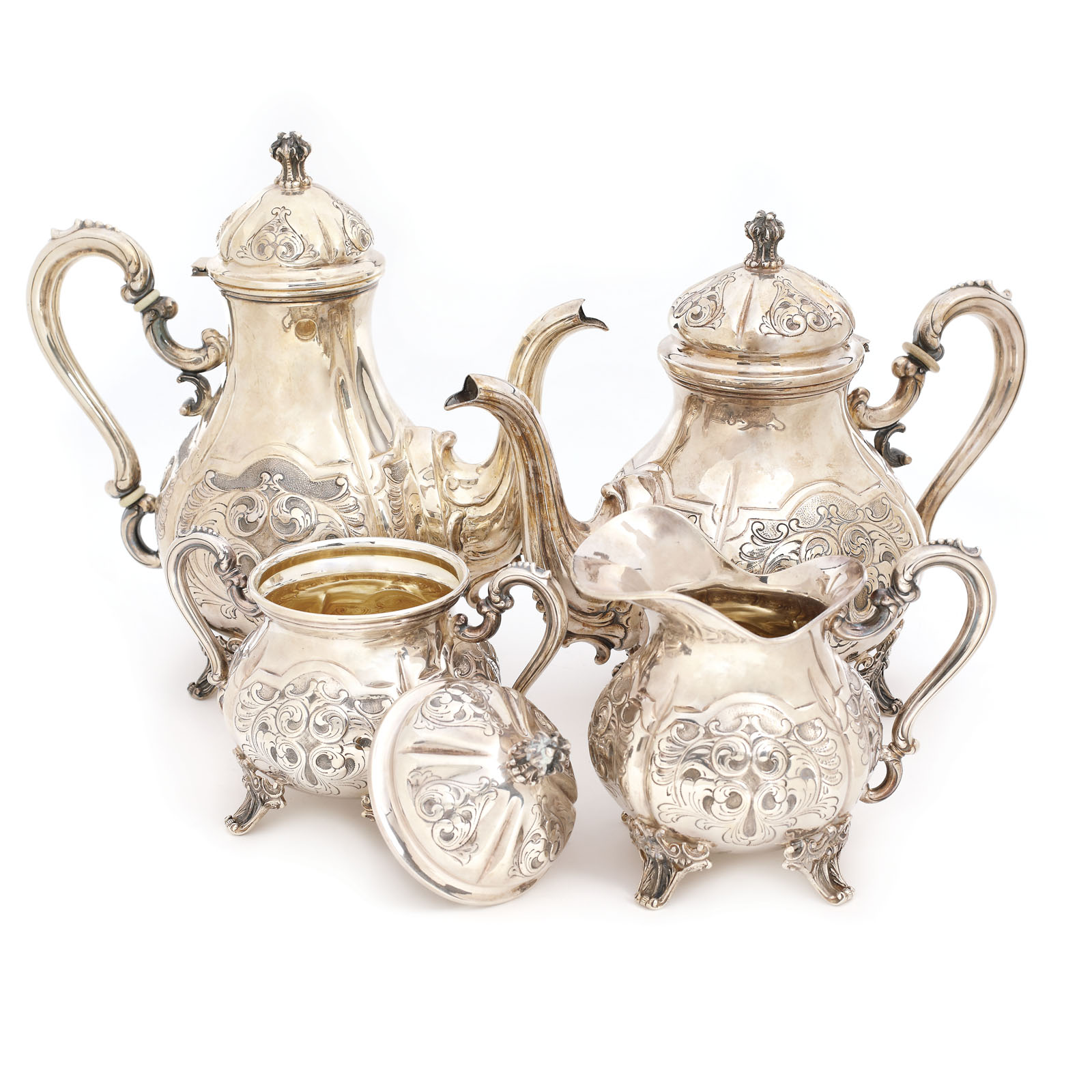 Silver set comprised of a teapot, a coffee pot, a sugar basin, and a milk ladle
