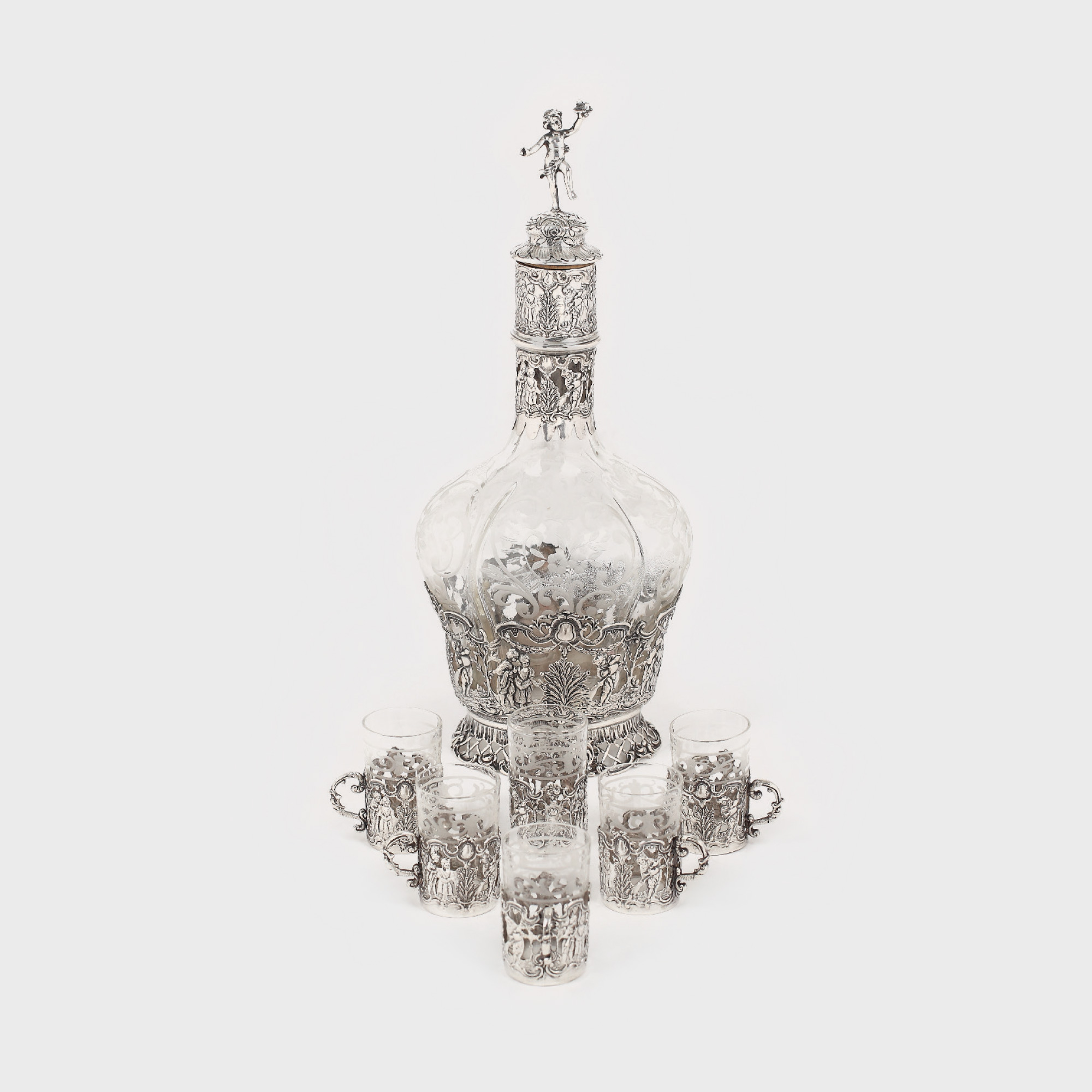 Serviciu format din carafă si 6 pahare, din argint Storck & Sinsheimer, decorat cu registre Neo-Rococo, cca. 1900