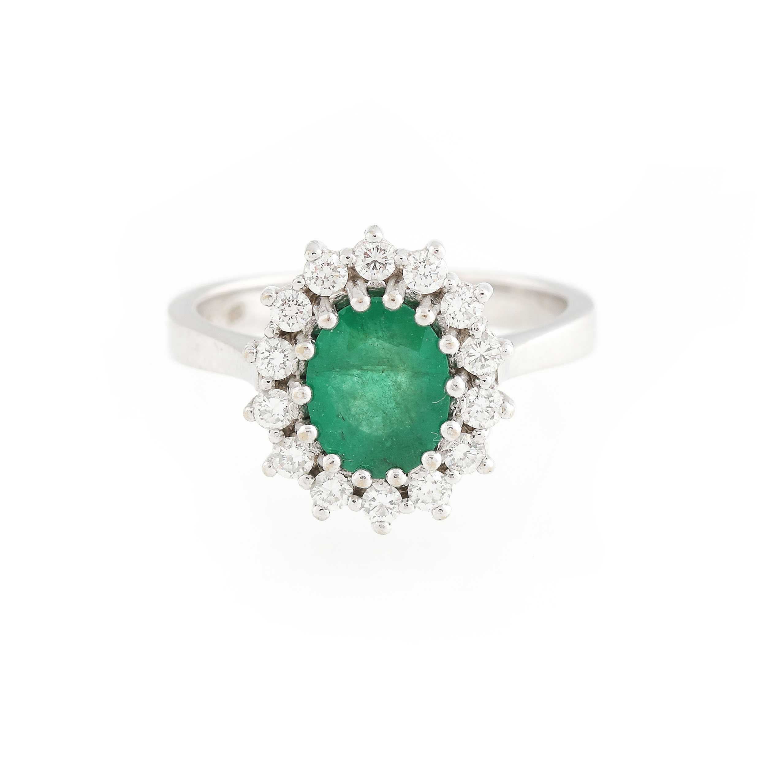 White gold ring, decorated with emerald surrounded by diamonds