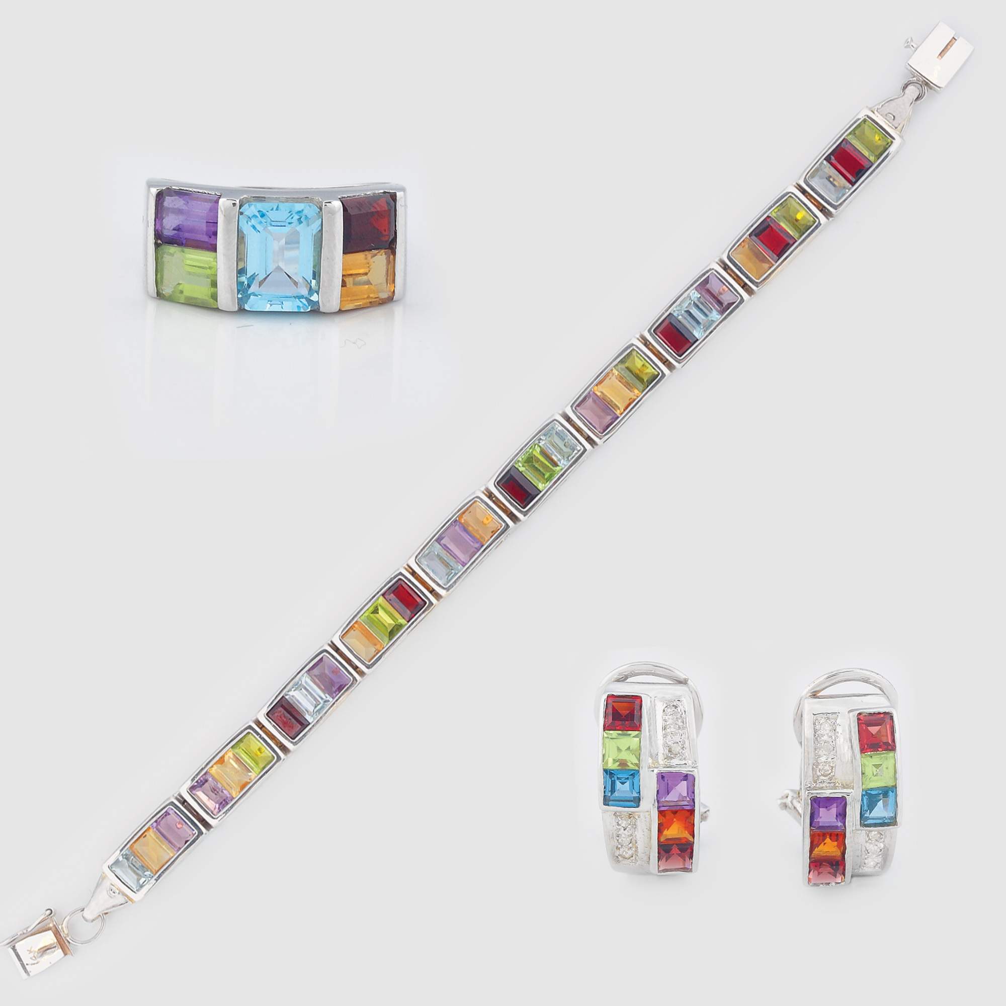 Set format din inel, pereche de cercei şi brăţară din aur alb, ornat cu un curcubeu de pietre (granate, peridote, citrine, acvamarine, ametiste, topaze)