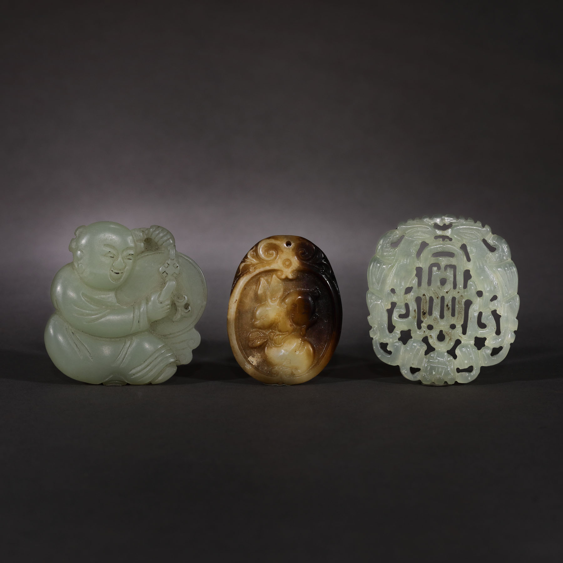 One jade and two serpentine pendants decorated with traditional motifs, end of the Qing dynasty, China, the beginning of the 20th century