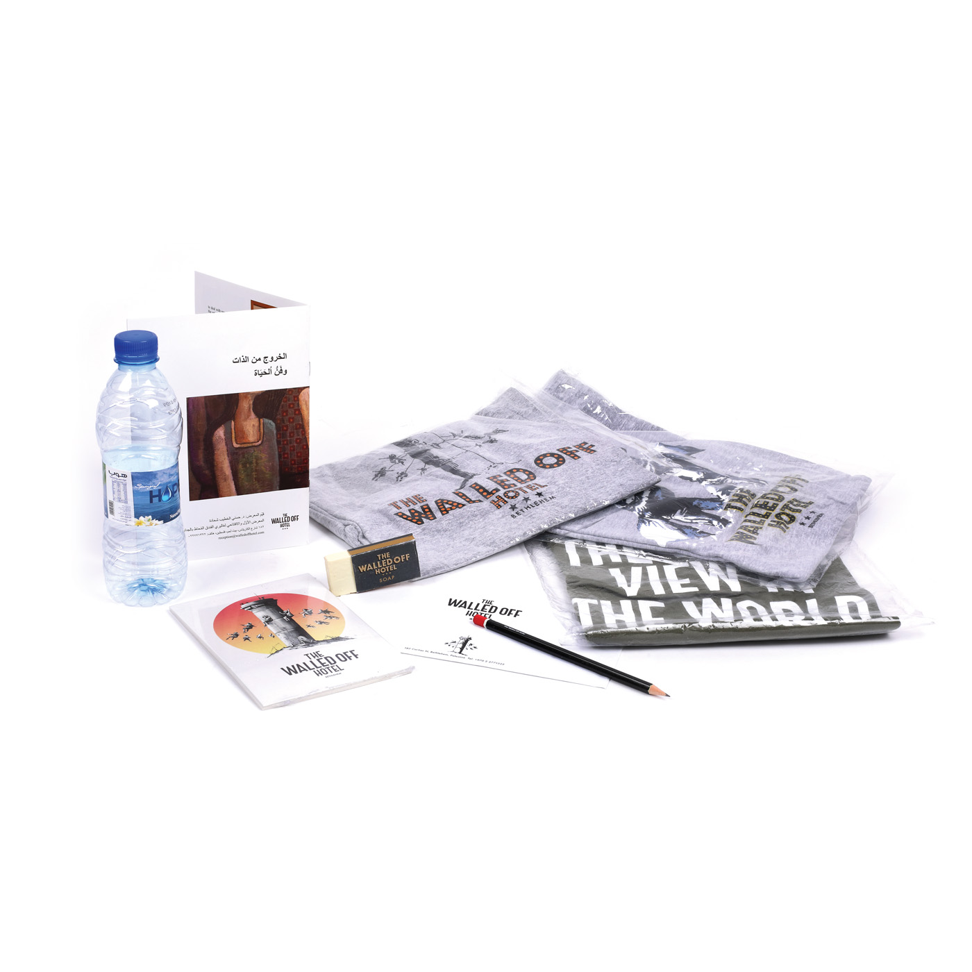 "The Walled Off Hotel" - set of three t-shirts, an artwork, postcards, pencil, soap, bottle of water, letter and a publication