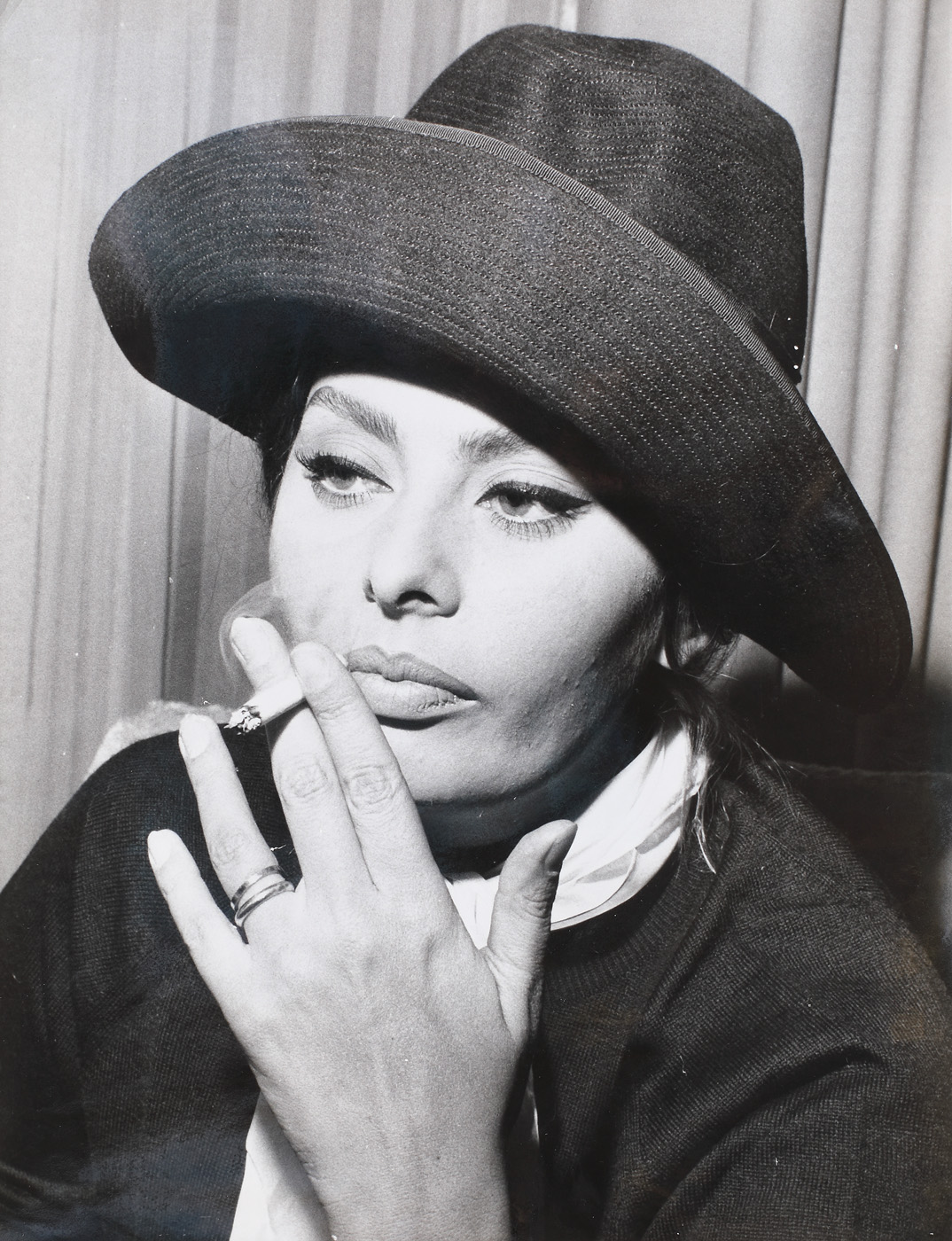 Sophia Lauren smoking in the New York airport lounge, waiting her flight to  Madrid, ca. 1960