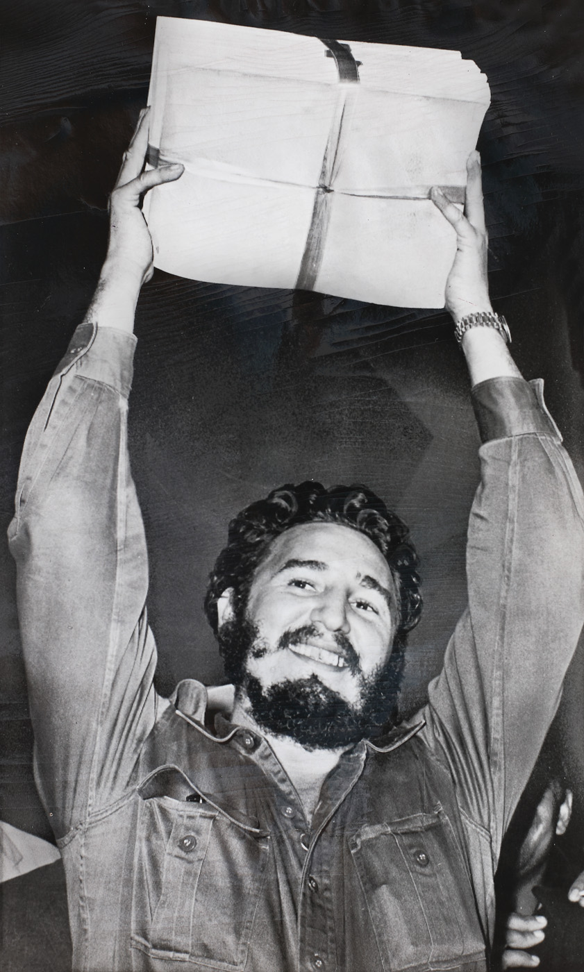 Fidel Castro showing the 30 milion dollar worth of cheques, donated to his campaign by workers from the sugar plantations, 1959