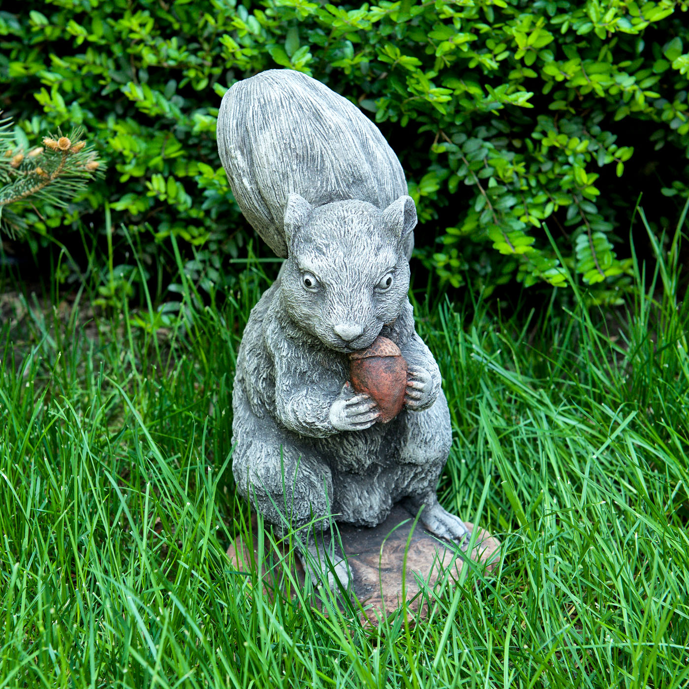 Decorative stone statuette in the shape of a squirrel with an acorn