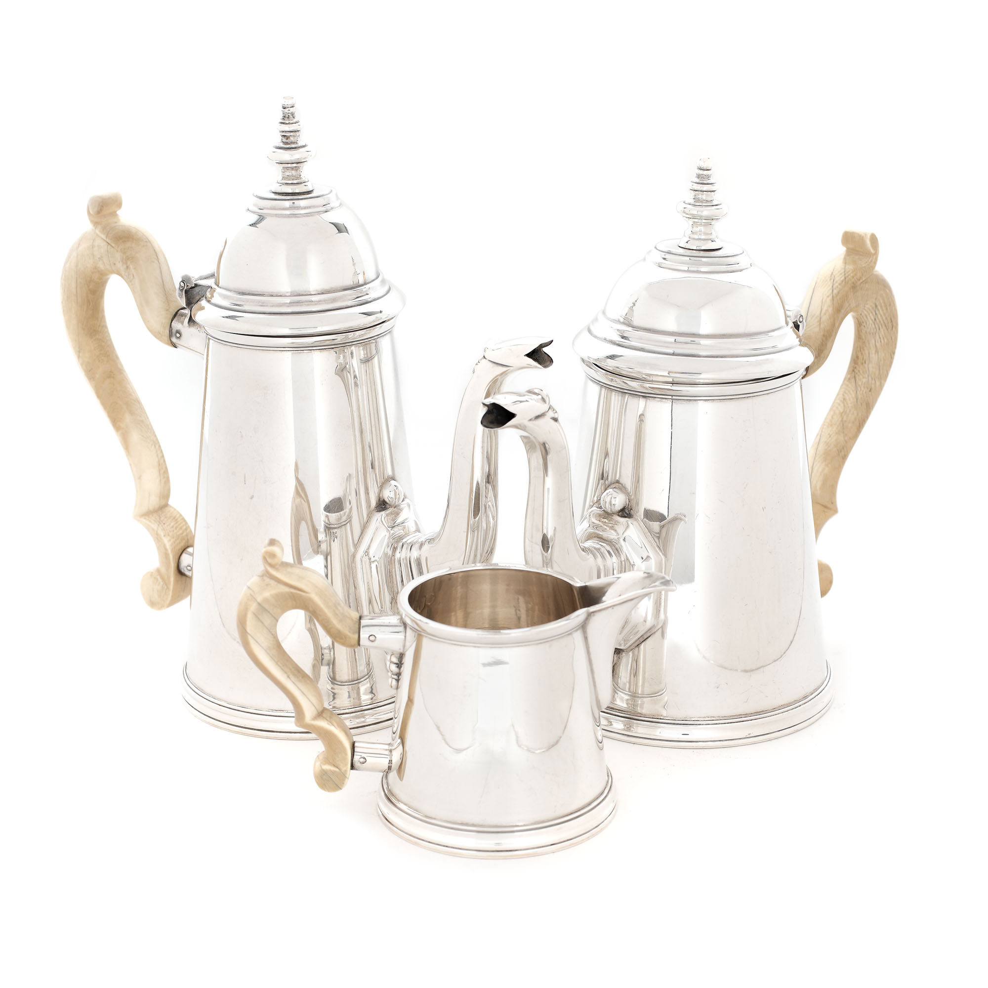 Silver tea or coffee set, consisting of two teapots and a milk pot, decorated with imposing ivory handles