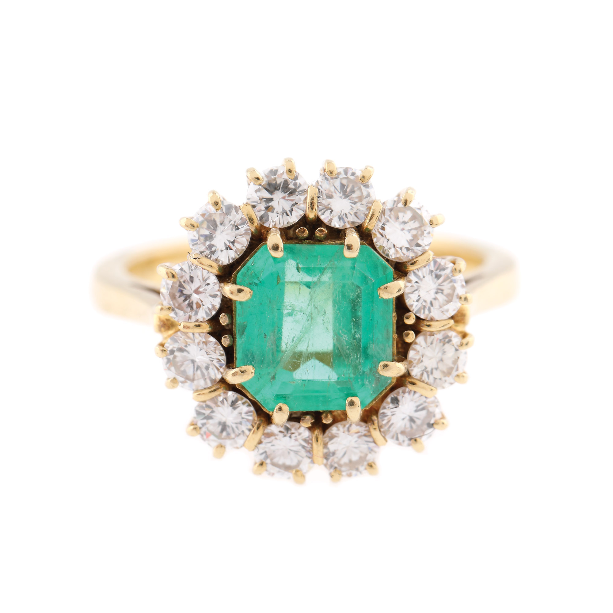 Gold ring, decorated with emerald surrounded by diamonds