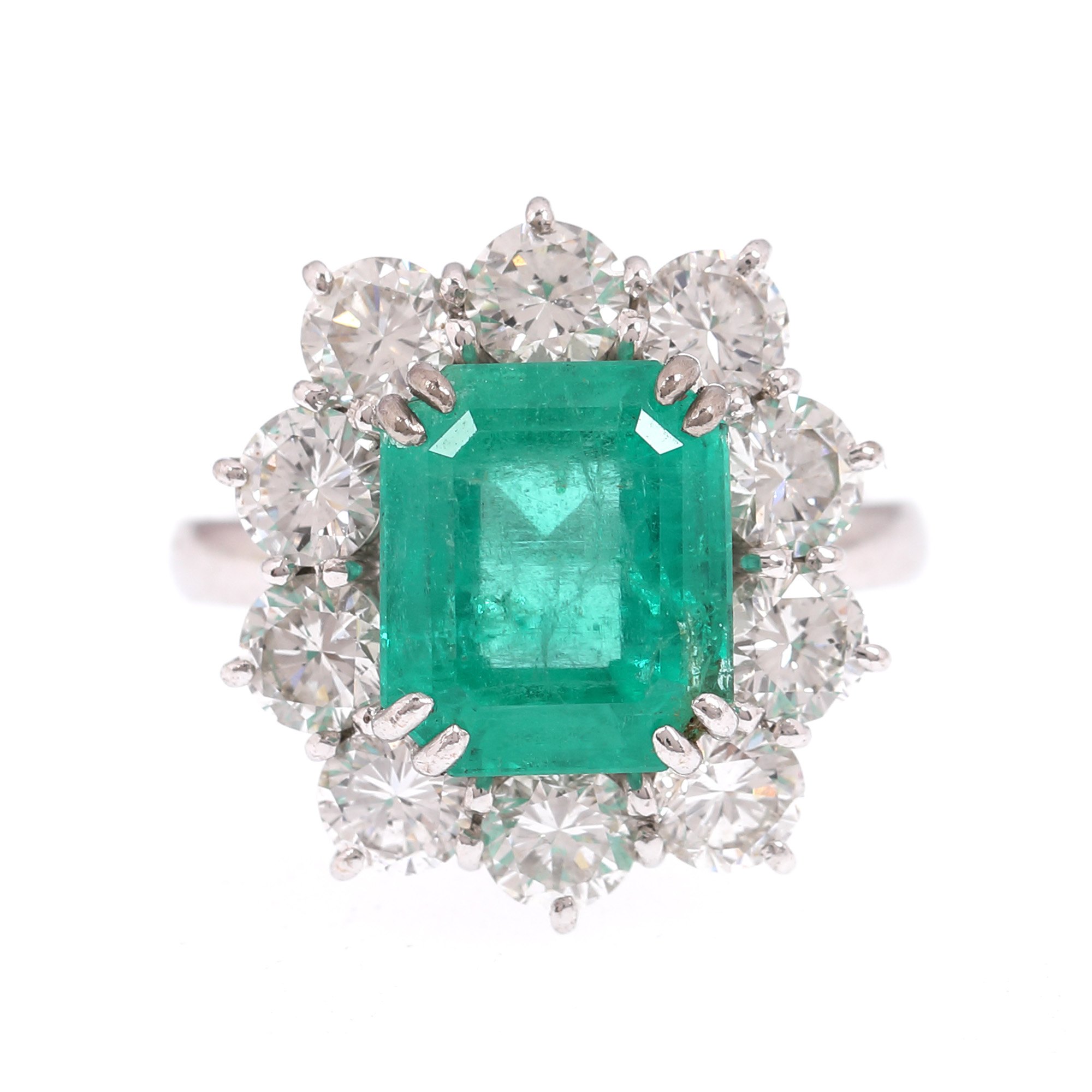 Gold ring, decorated with emerald surrounded by diamonds
