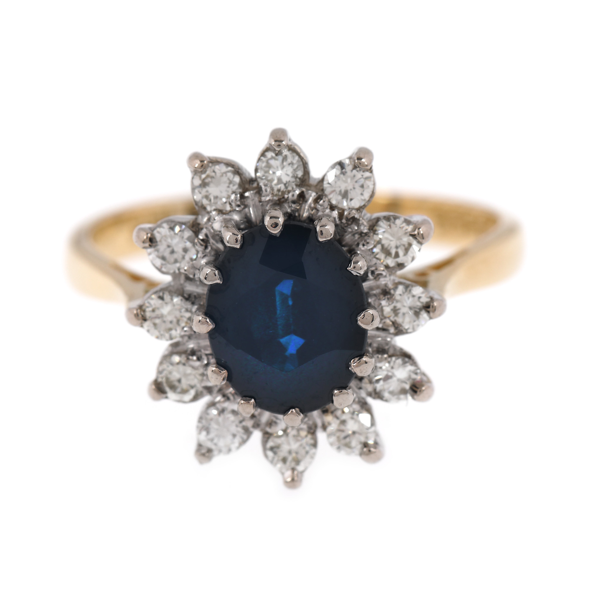 Two-tone gold ring, decorated with sapphire surrounded by diamonds