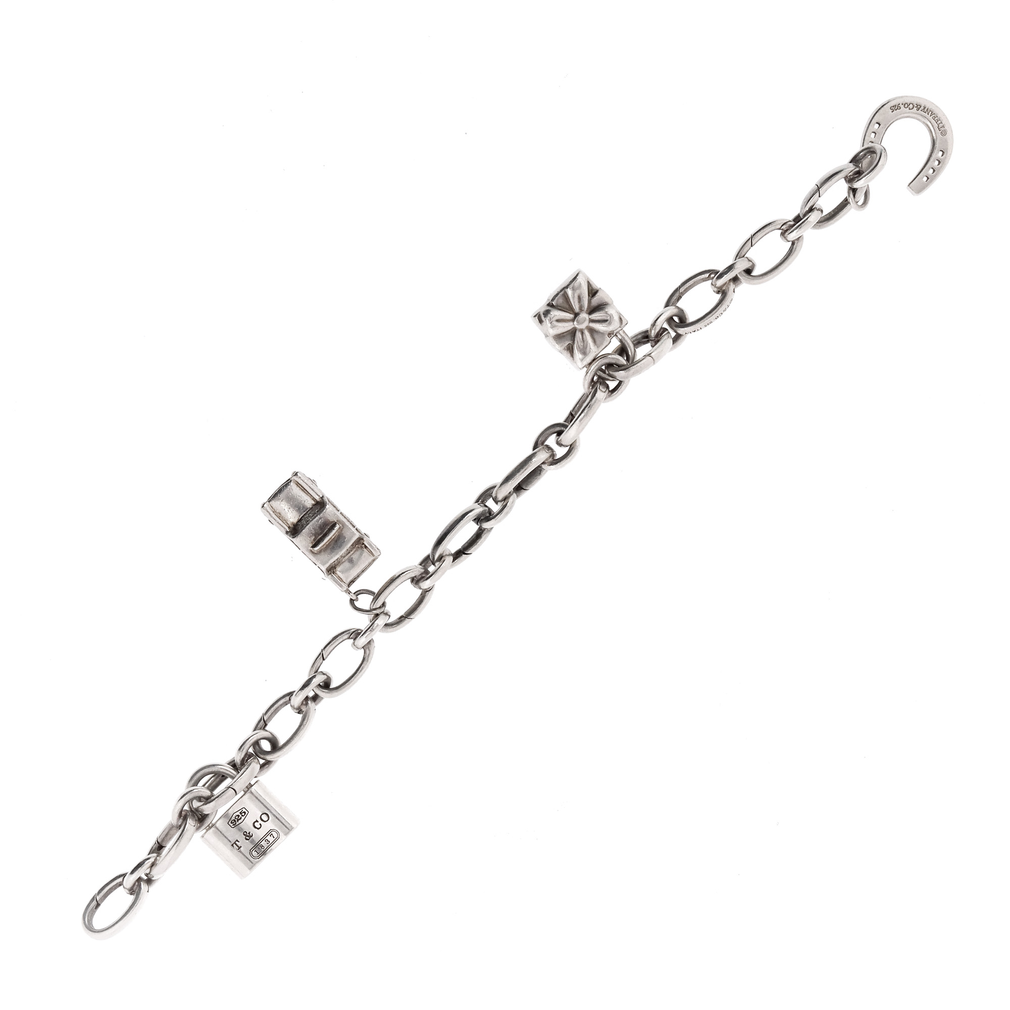 Tiffany & Co. silver bracelet, decorated with four charms, in the original box