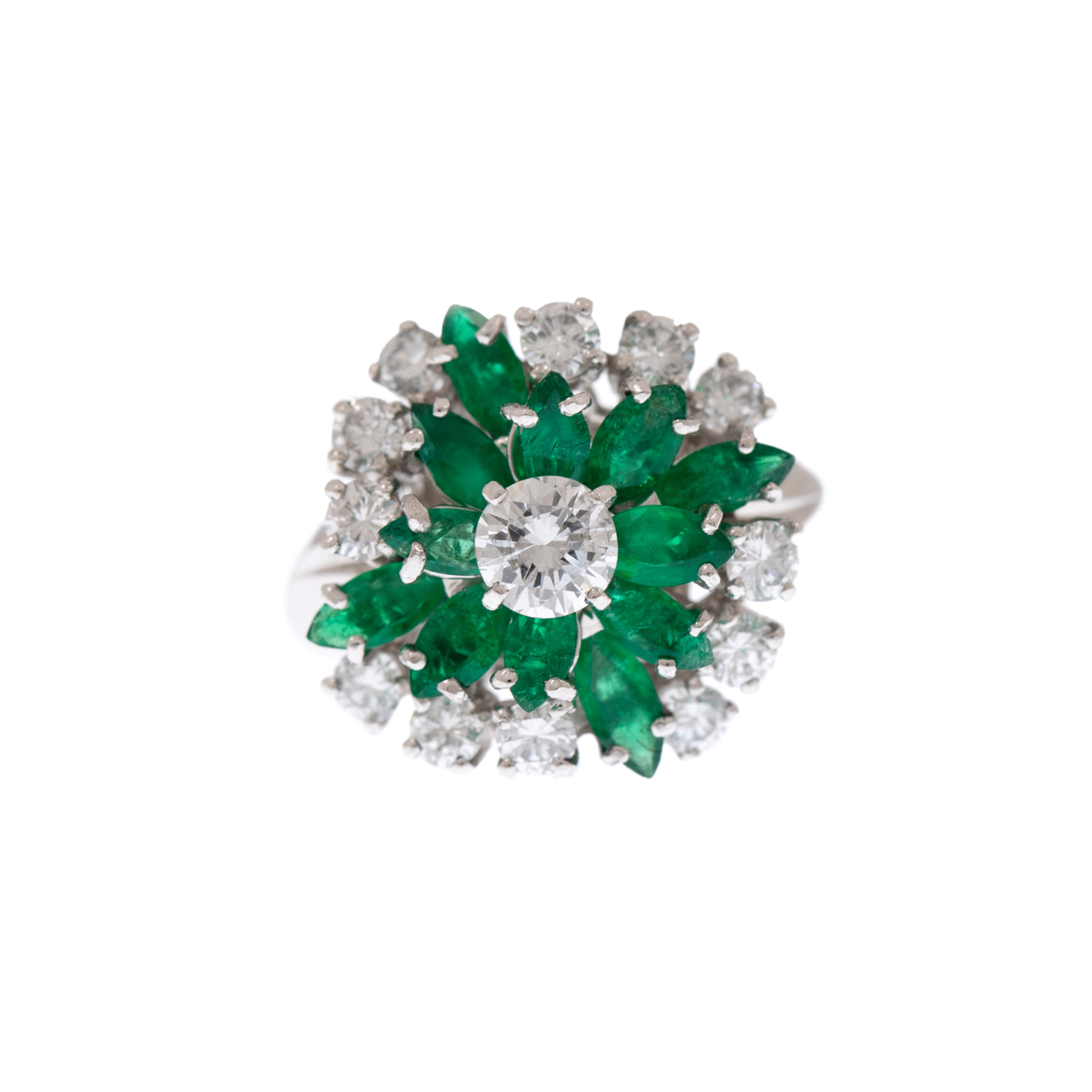 White gold and platinum flower-shaped ring, adorned with diamonds and emeralds