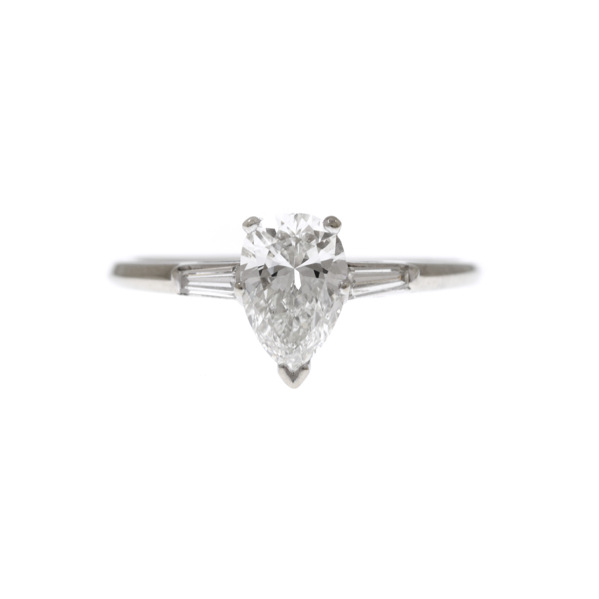 White gold ring adorned with solitaire central diamond and 'baguette' cut diamonds set side by side
