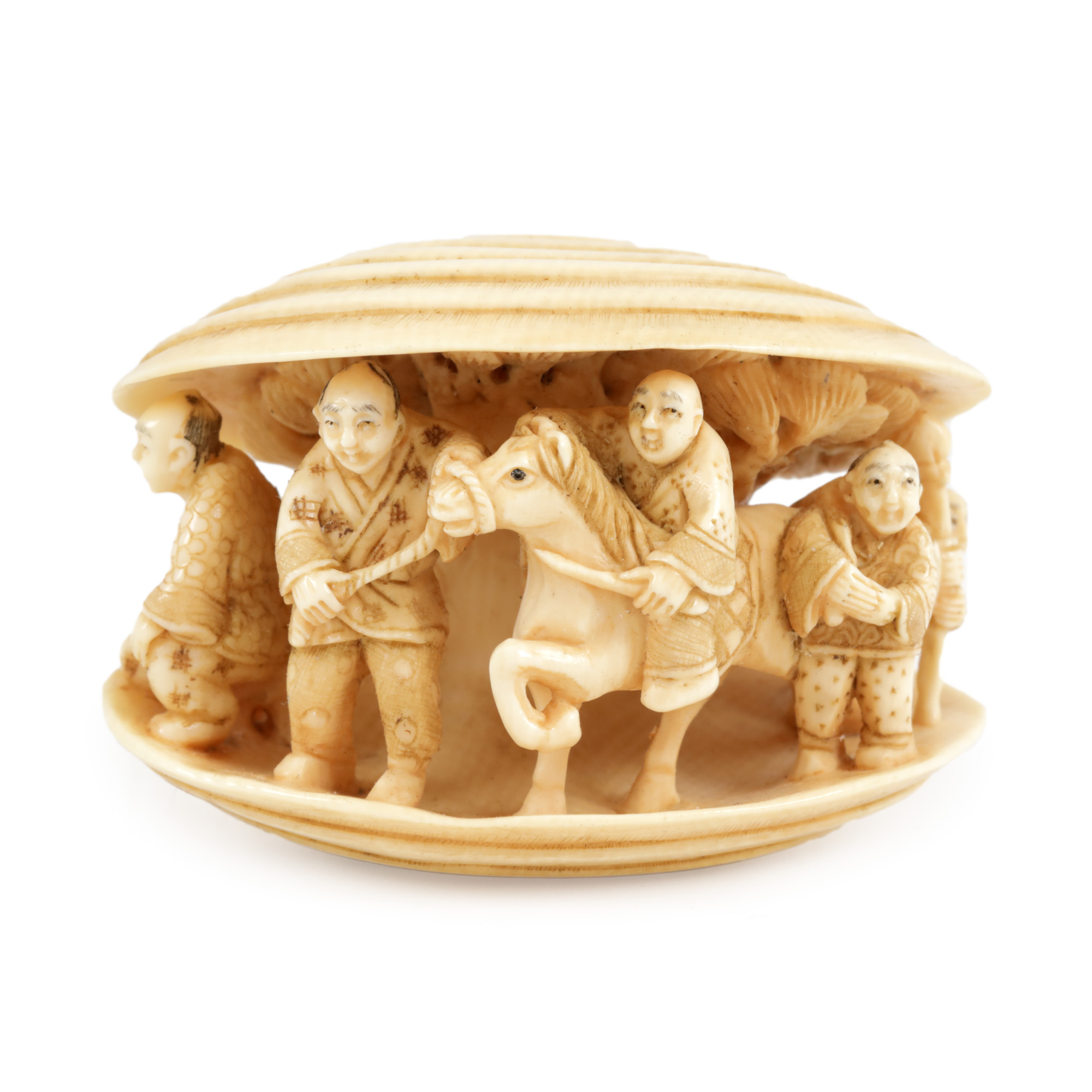 Ivory Netsuke, illustrating a nobleman with his servants, sheltering under a pine, signed, Meiji period, Japan, early 20th century