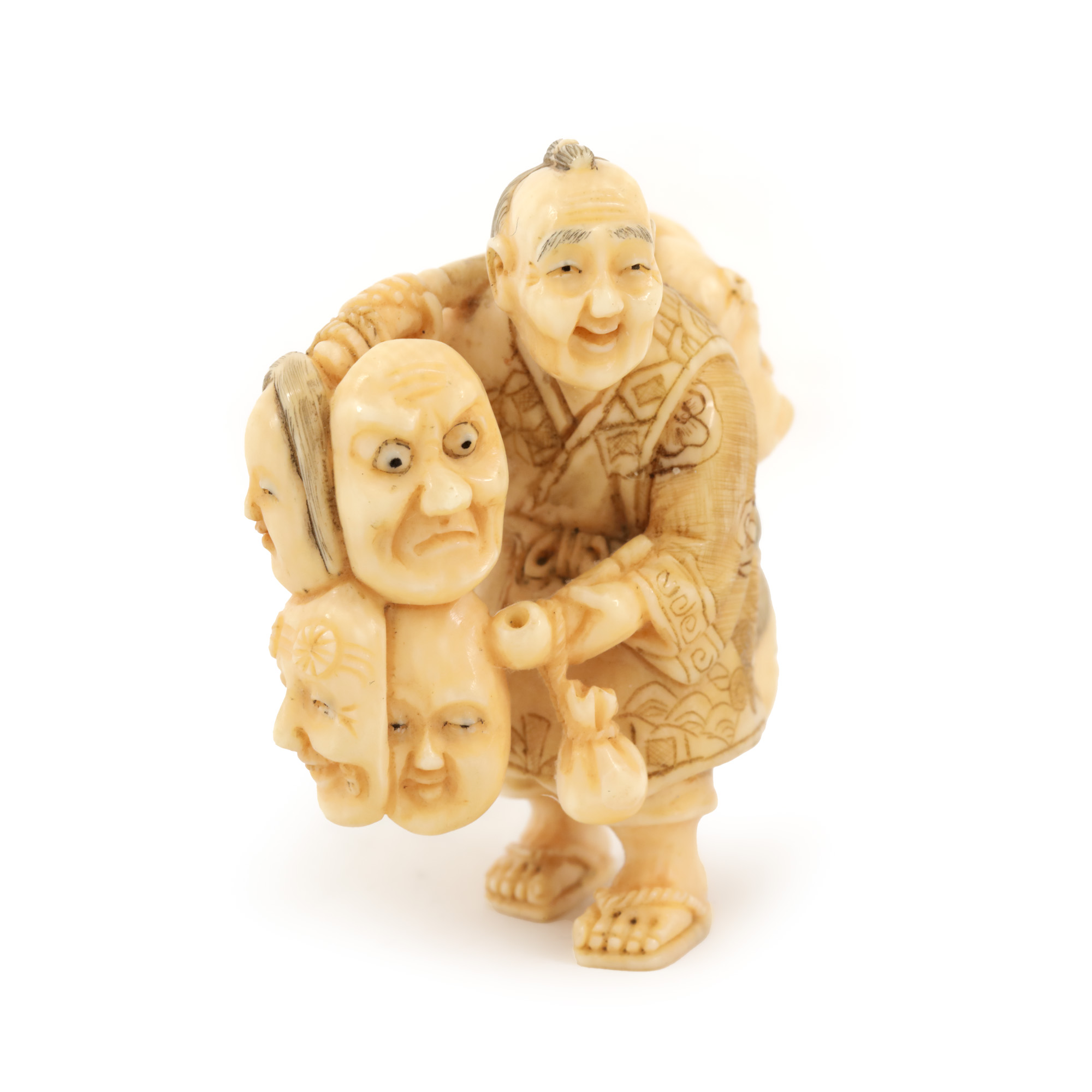 Netsuke din fildeș, reprezetând un meștesugar și zece măști de teatru Noh, semnat, perioada Edo, Japonia, începutul sec. XIX, piesă rară, de colecție