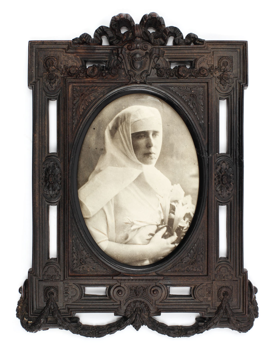 Press photograph of Queen Marie in charity nurse uniform, in richly ornamented period frame