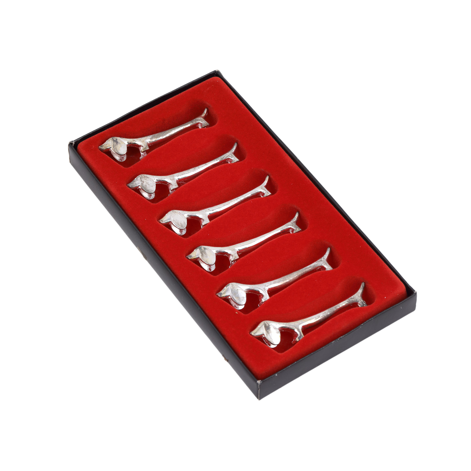 Lot consisting of six knife rests, illustrating dachshunds, in the original box