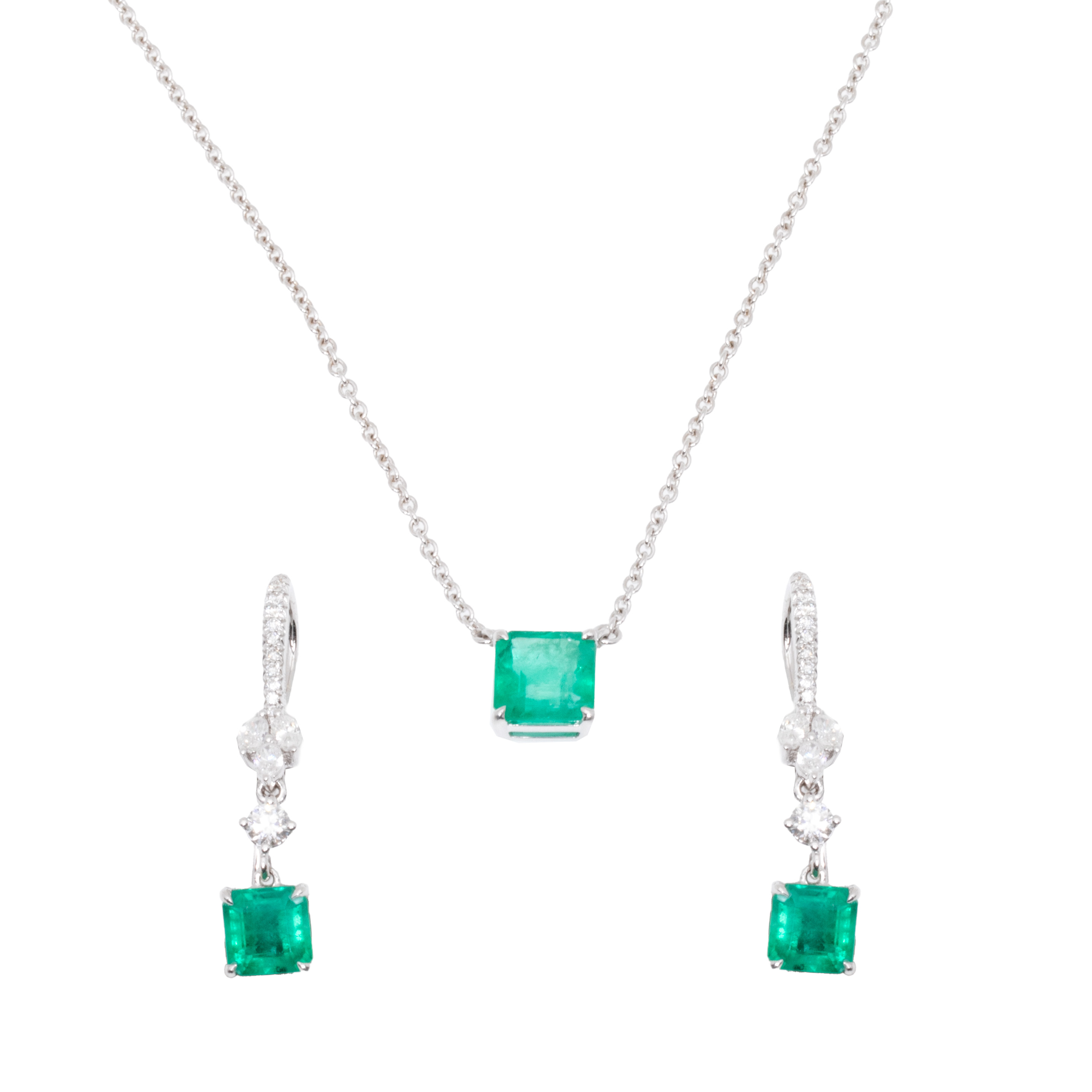 White gold set, consisting of paired earrings and pendant chain, decorated with emeralds and diamonds