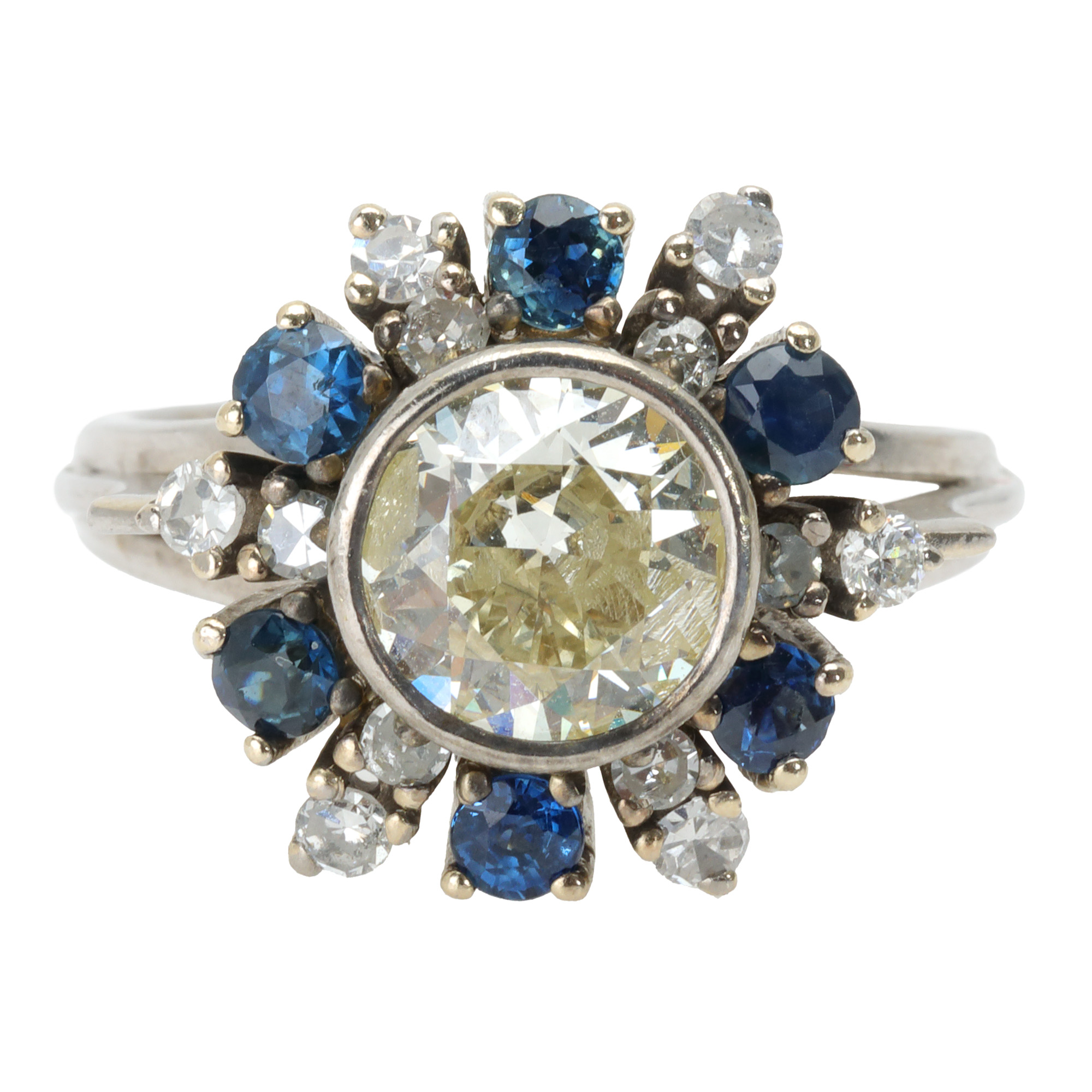 White gold ring, decorated with a central yellow diamond, surrounded by sapphires and brilliants