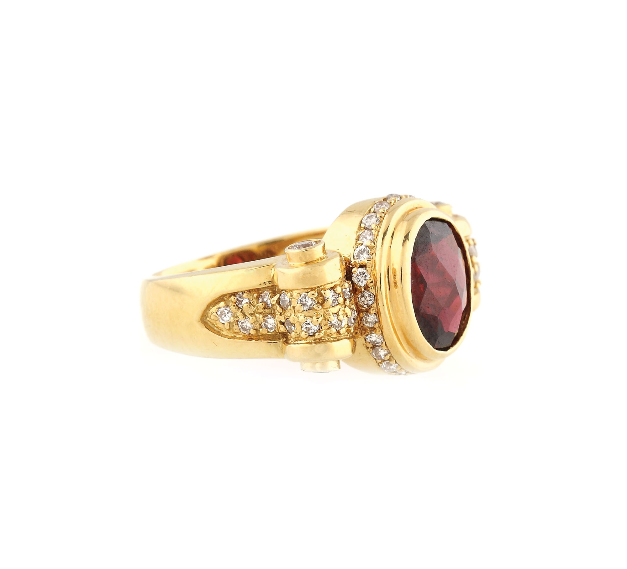 Gold ring ornate with garnet and diamonds