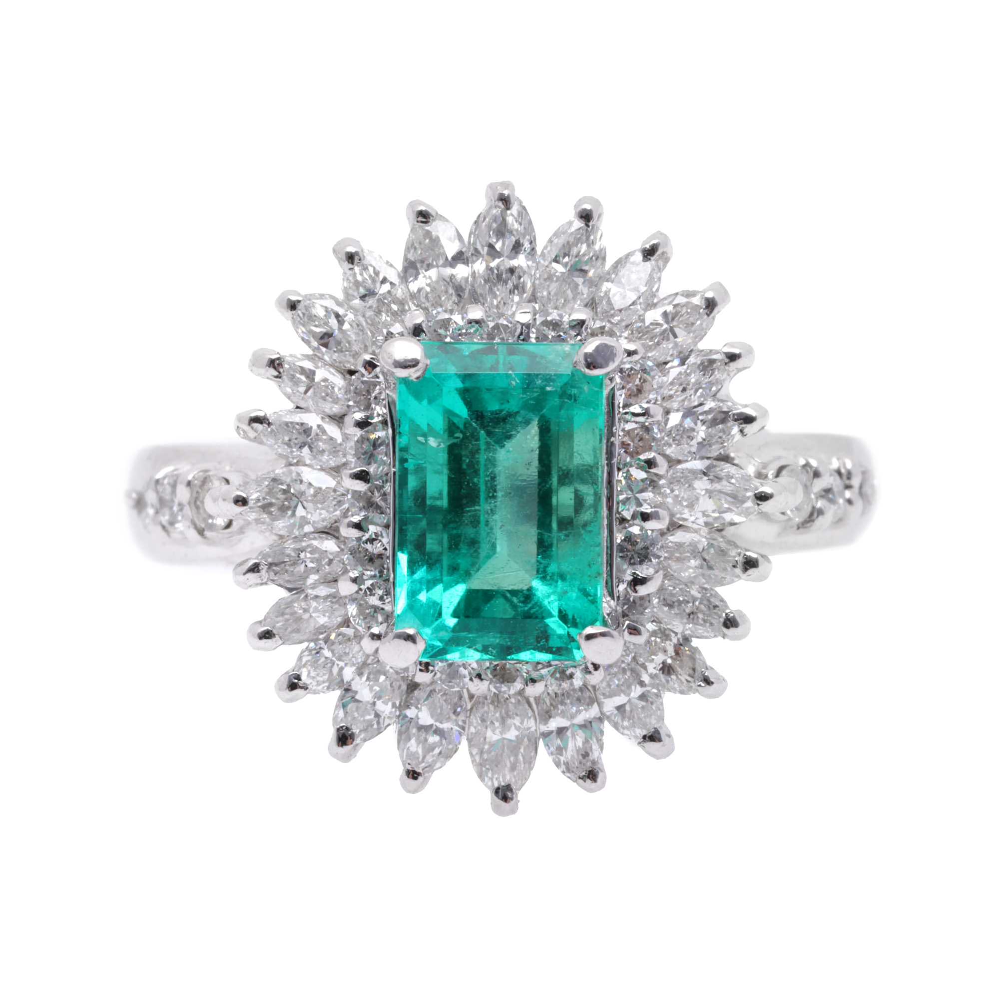 Platinum ring, decorated with a central emerald cut emerald, surrounded by diamonds