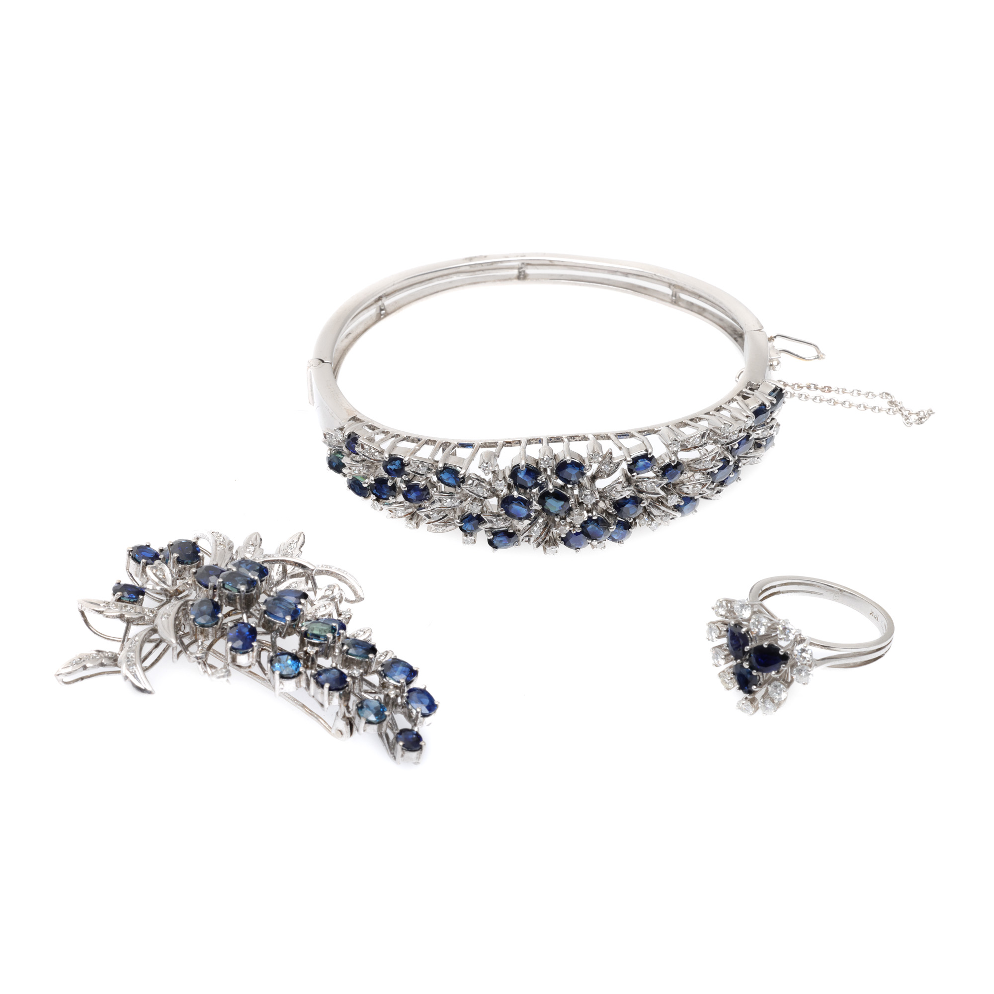 White gold set, consisting of fixed bracelet, ring and brooch, decorated with diamonds and sapphires